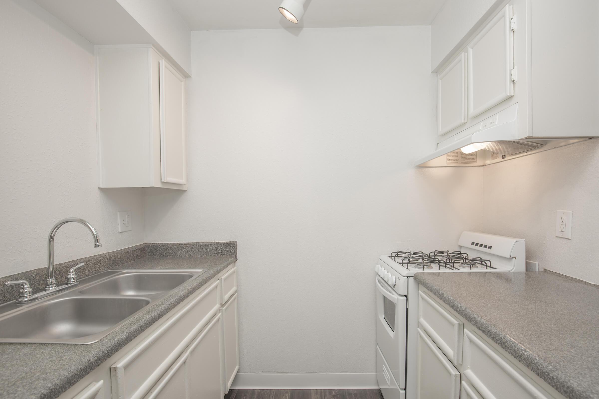 a kitchen with a sink and a refrigerator