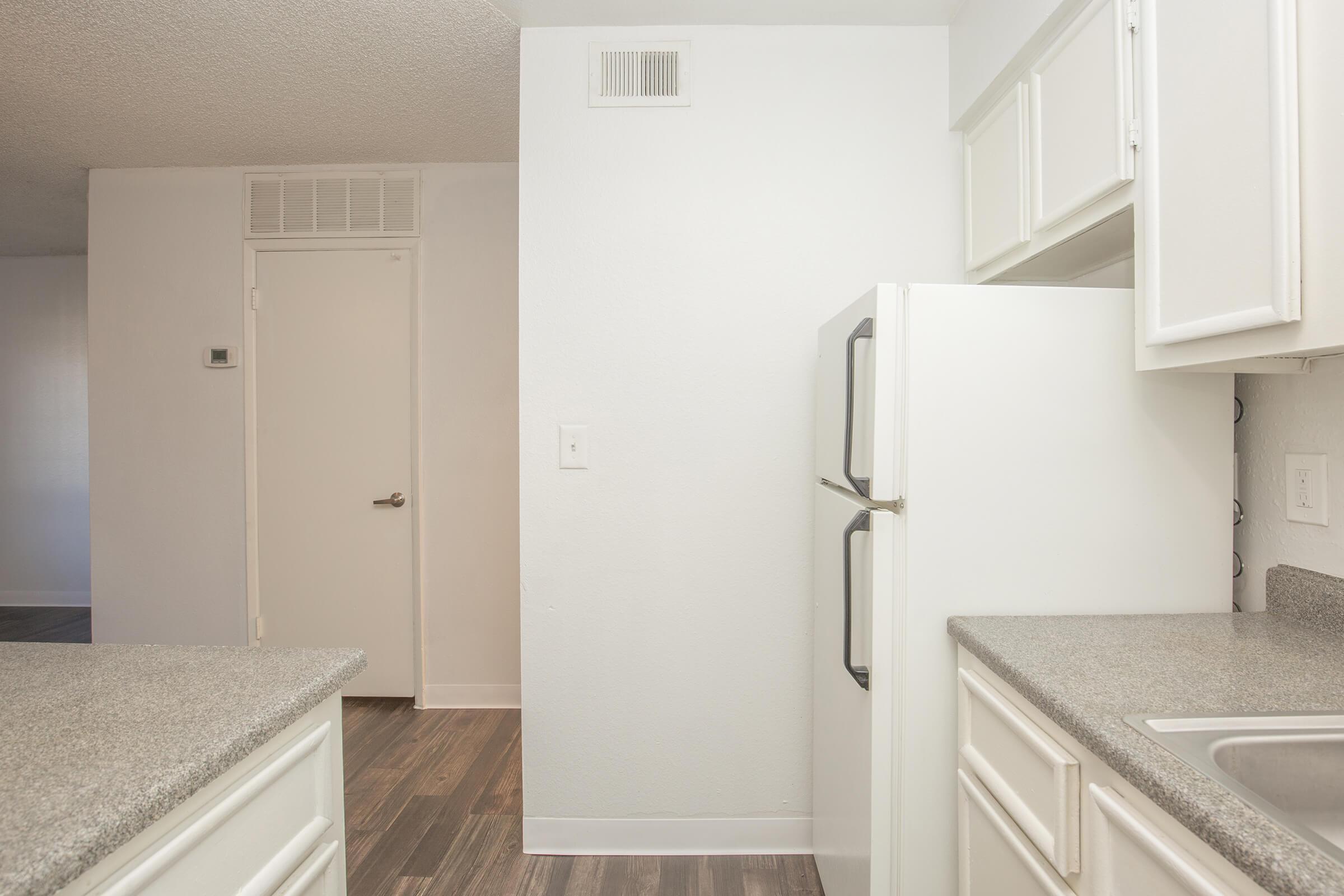 a white refrigerator freezer sitting inside of a kitchen