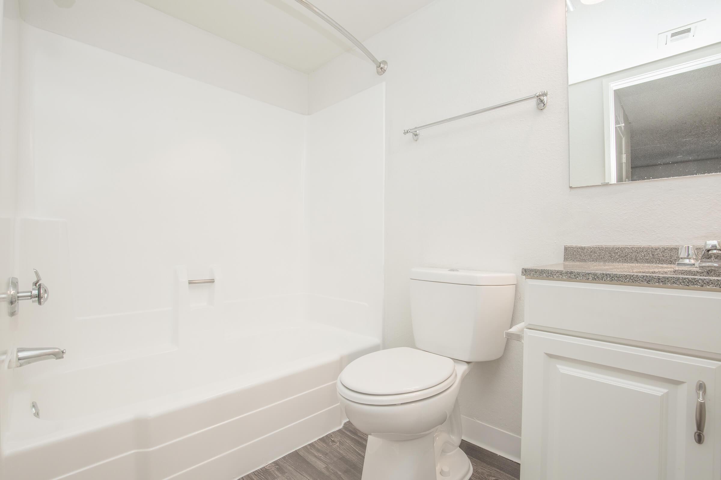 a white tub sitting next to a shower