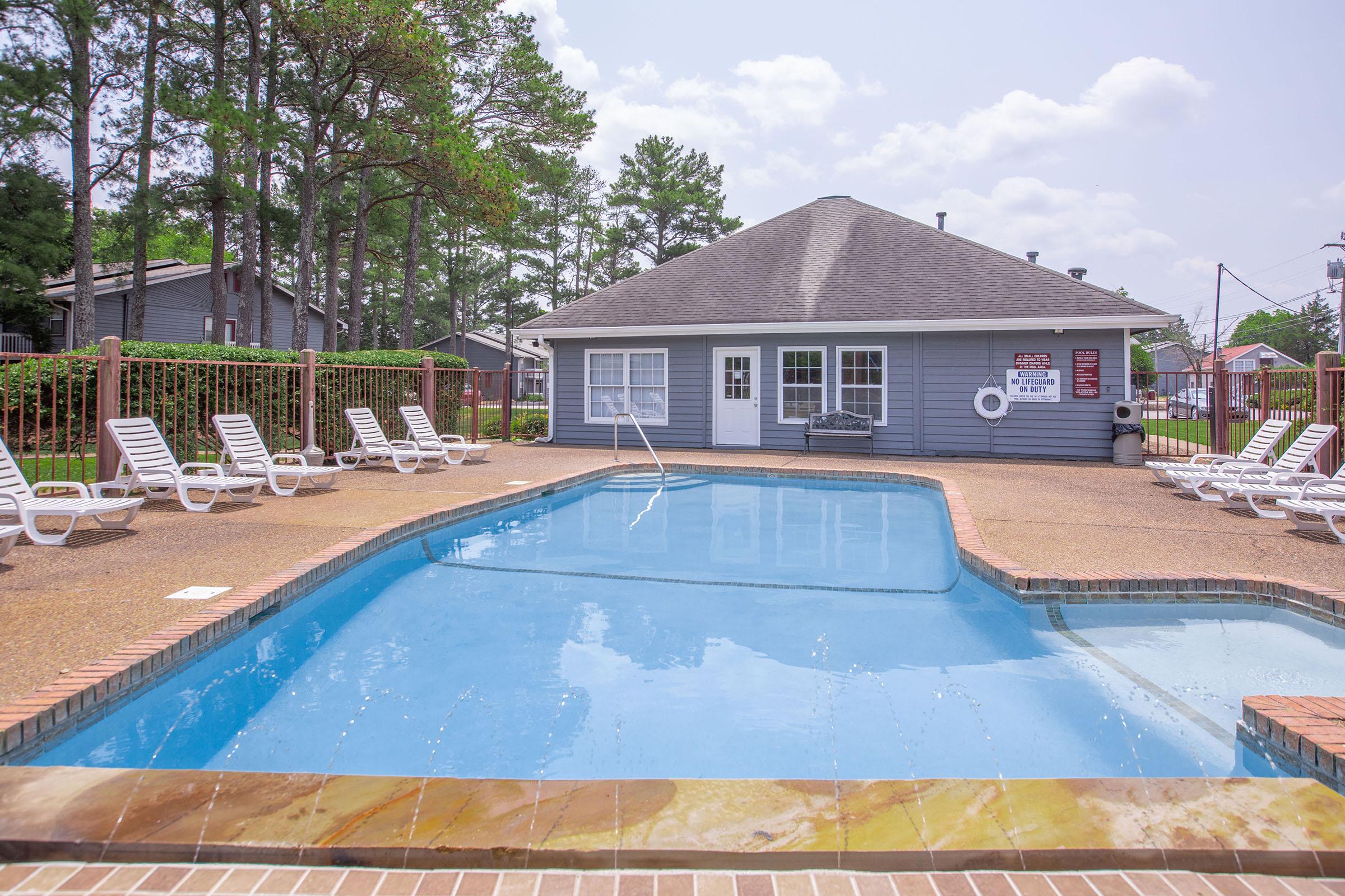 a house with a pool outside of a building