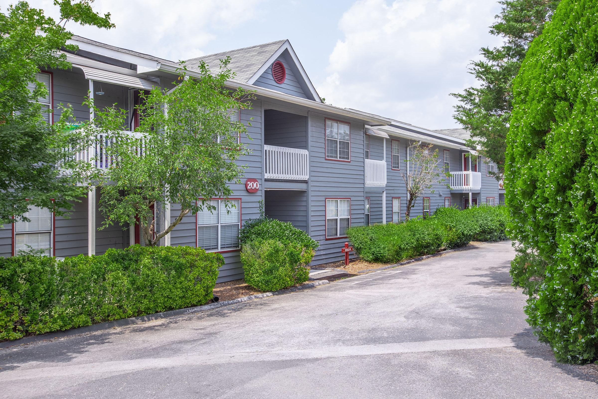 a house with bushes in front of a building