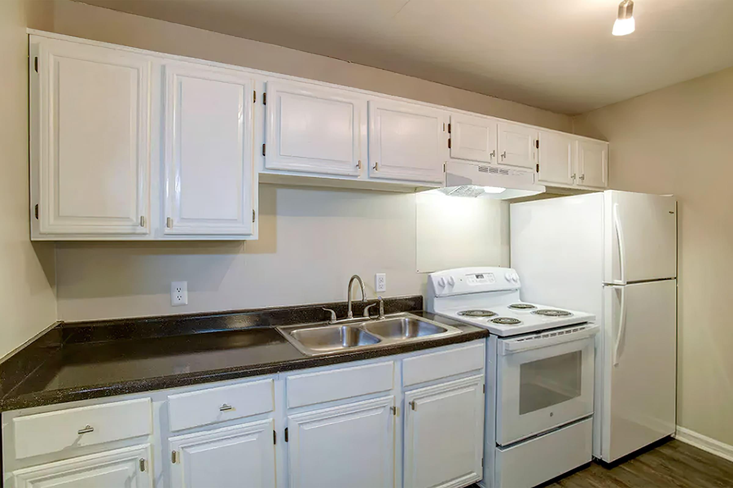 a stove top oven sitting inside of a kitchen