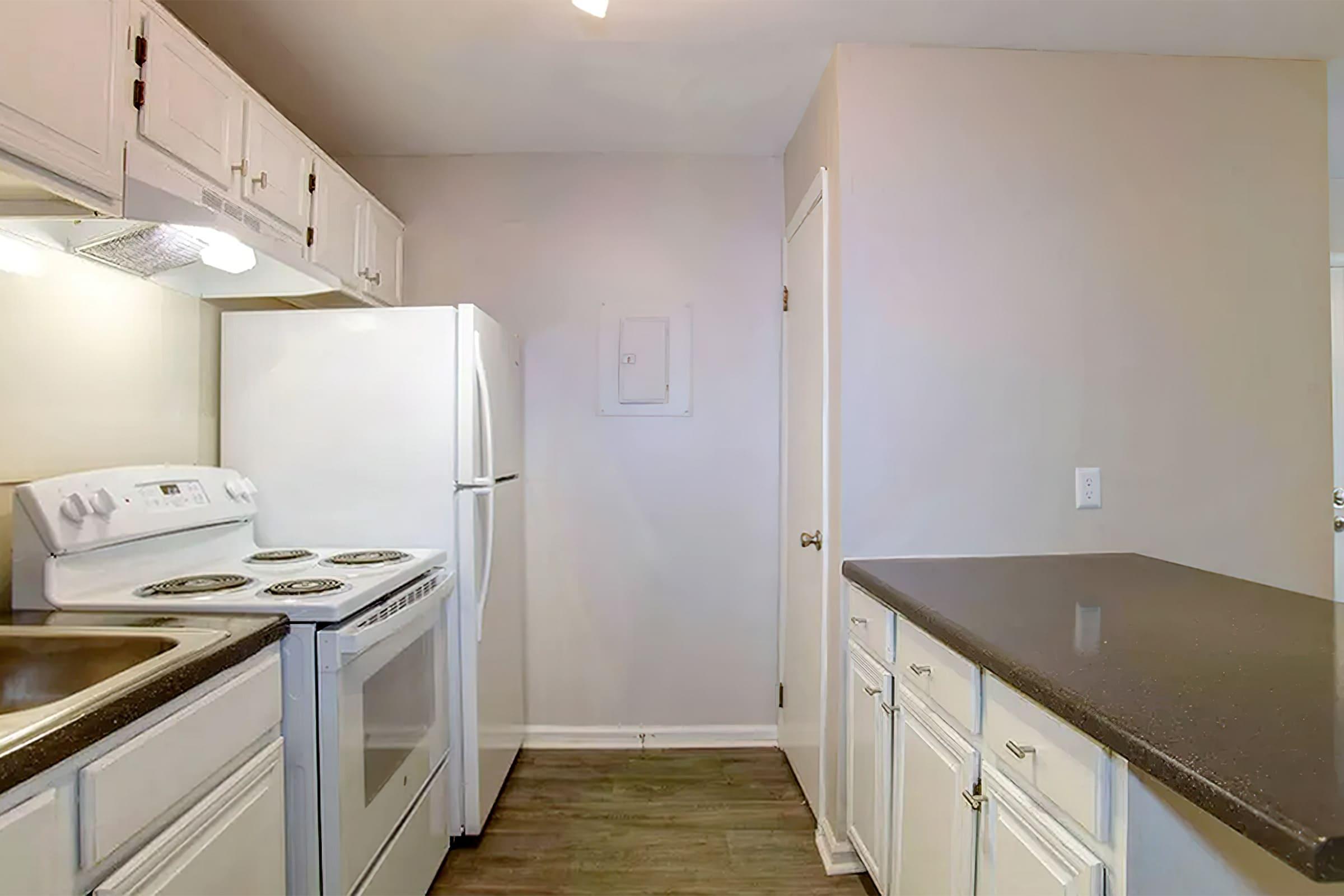 a kitchen with a sink and a refrigerator