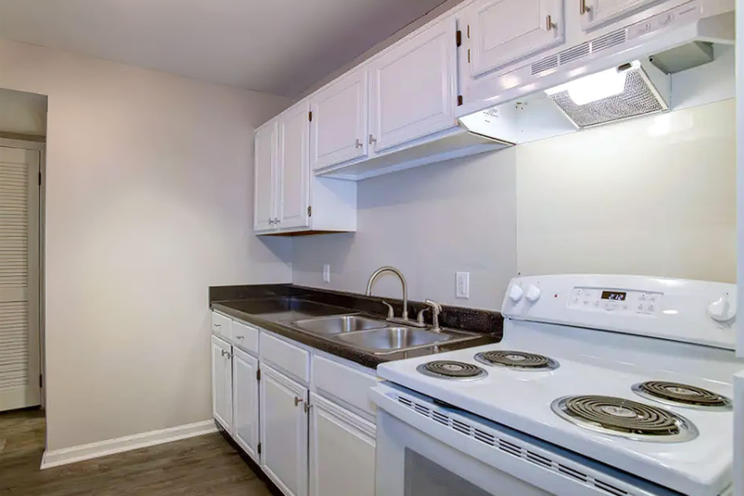 a stove top oven sitting inside of a kitchen