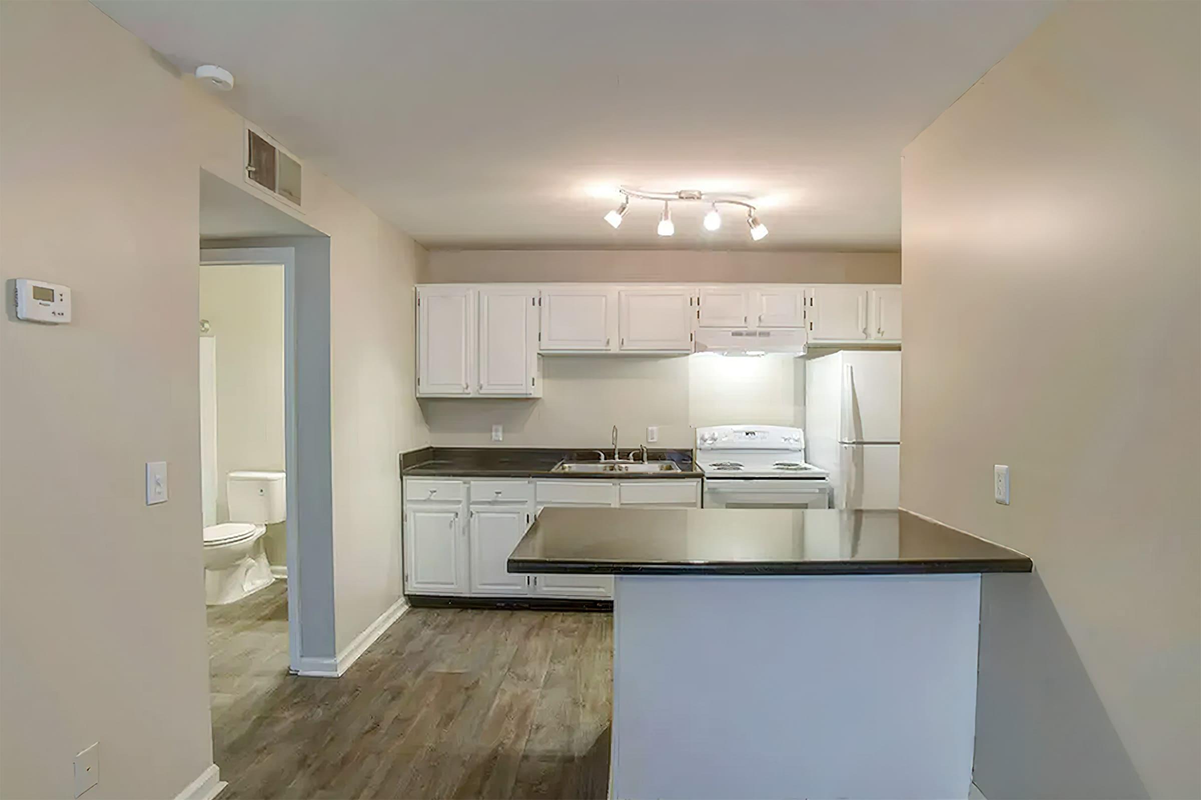 a kitchen with a sink and a refrigerator