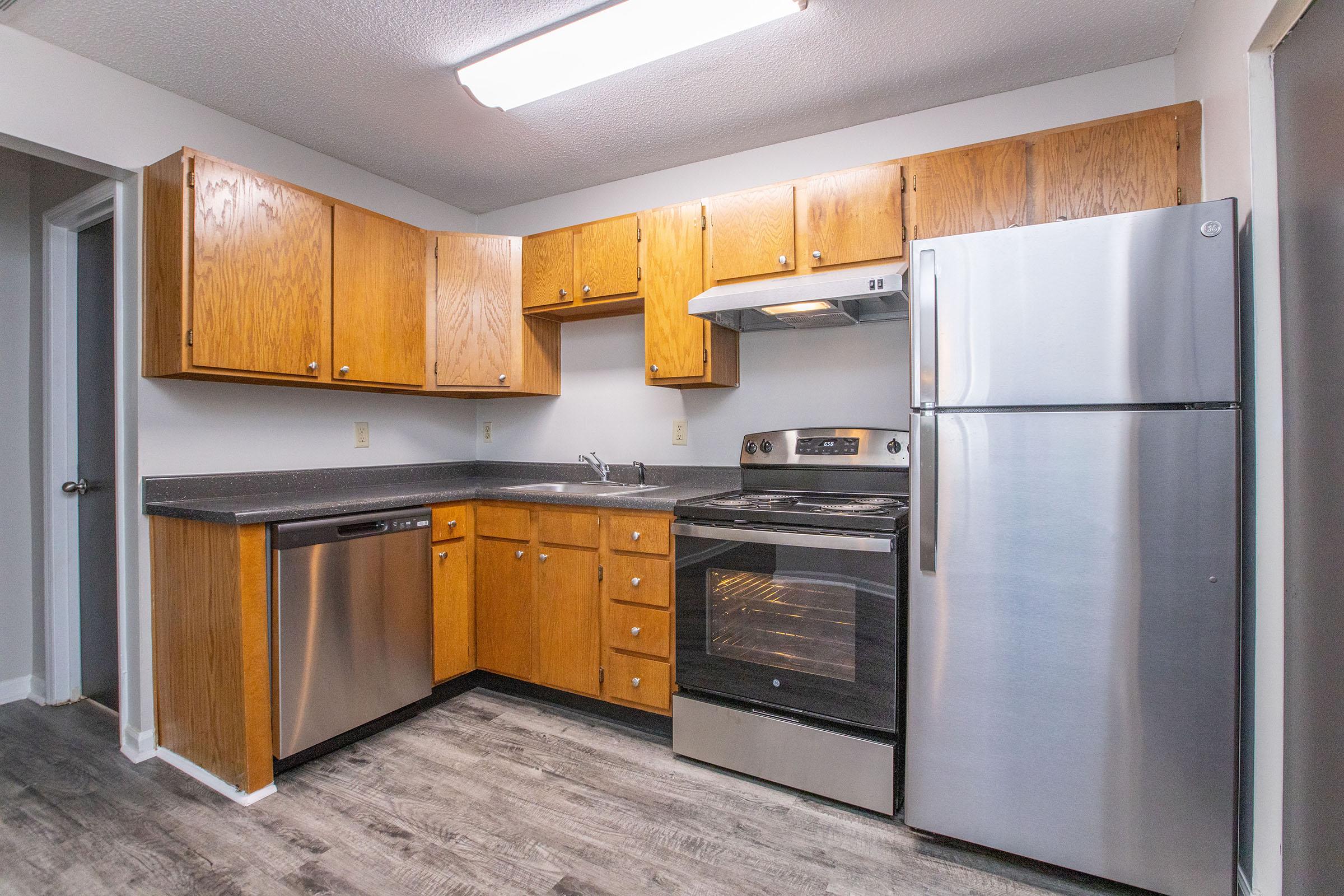 a kitchen with a stove and a refrigerator