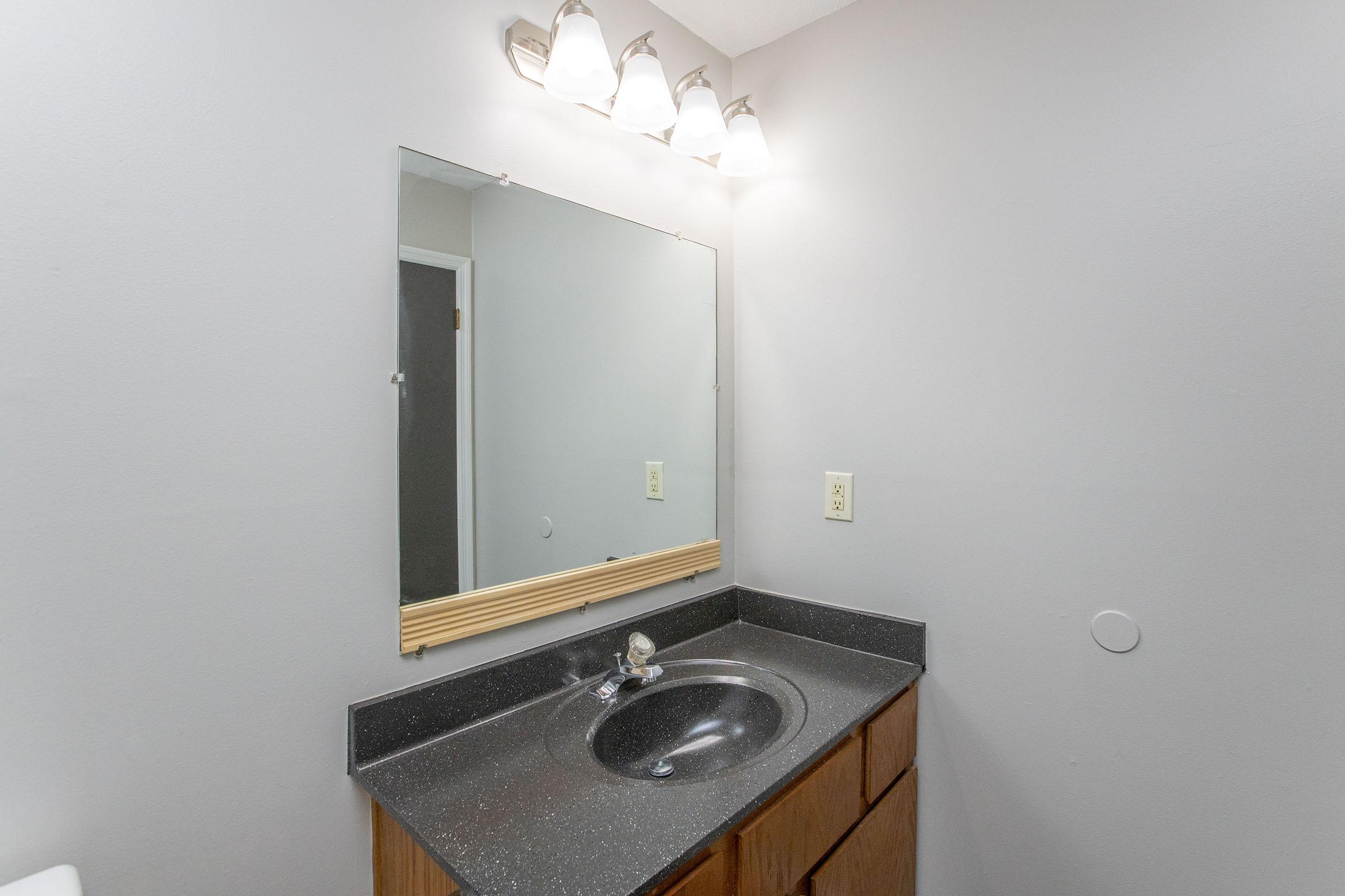 a kitchen with a sink and a mirror