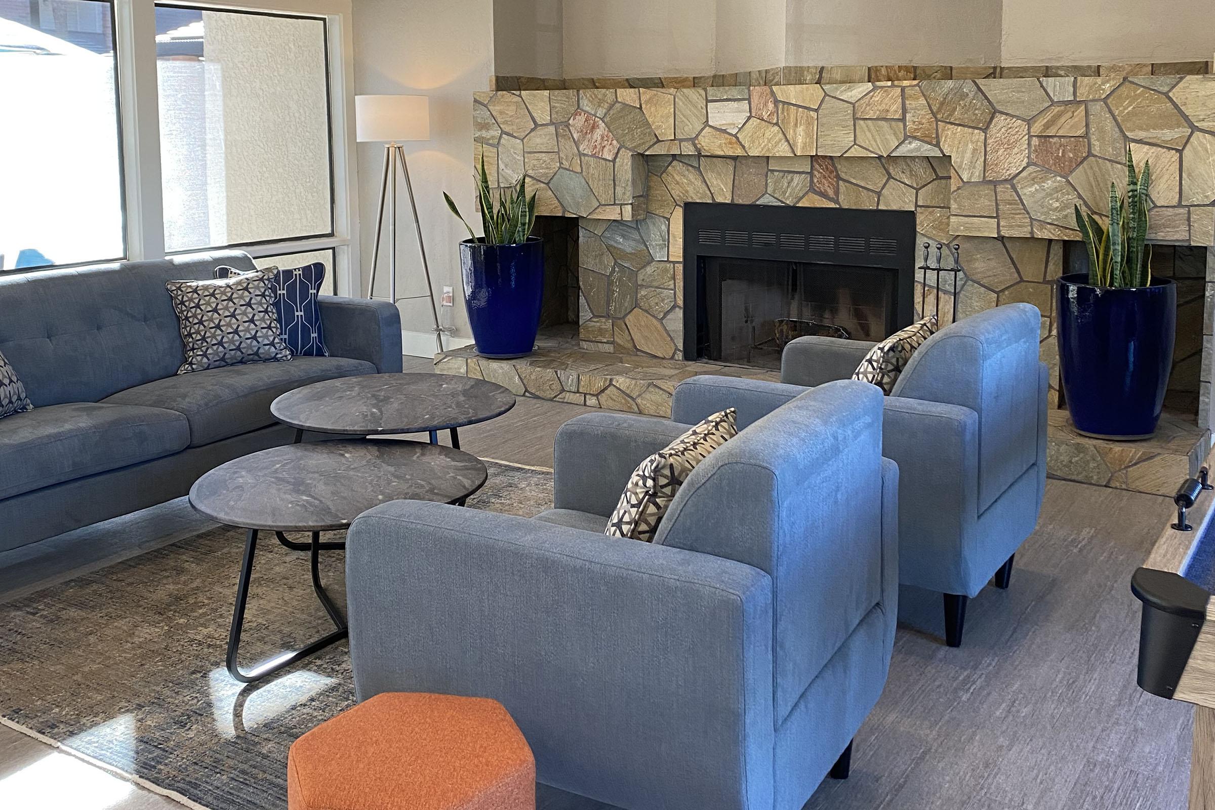 a living room filled with furniture and a fireplace