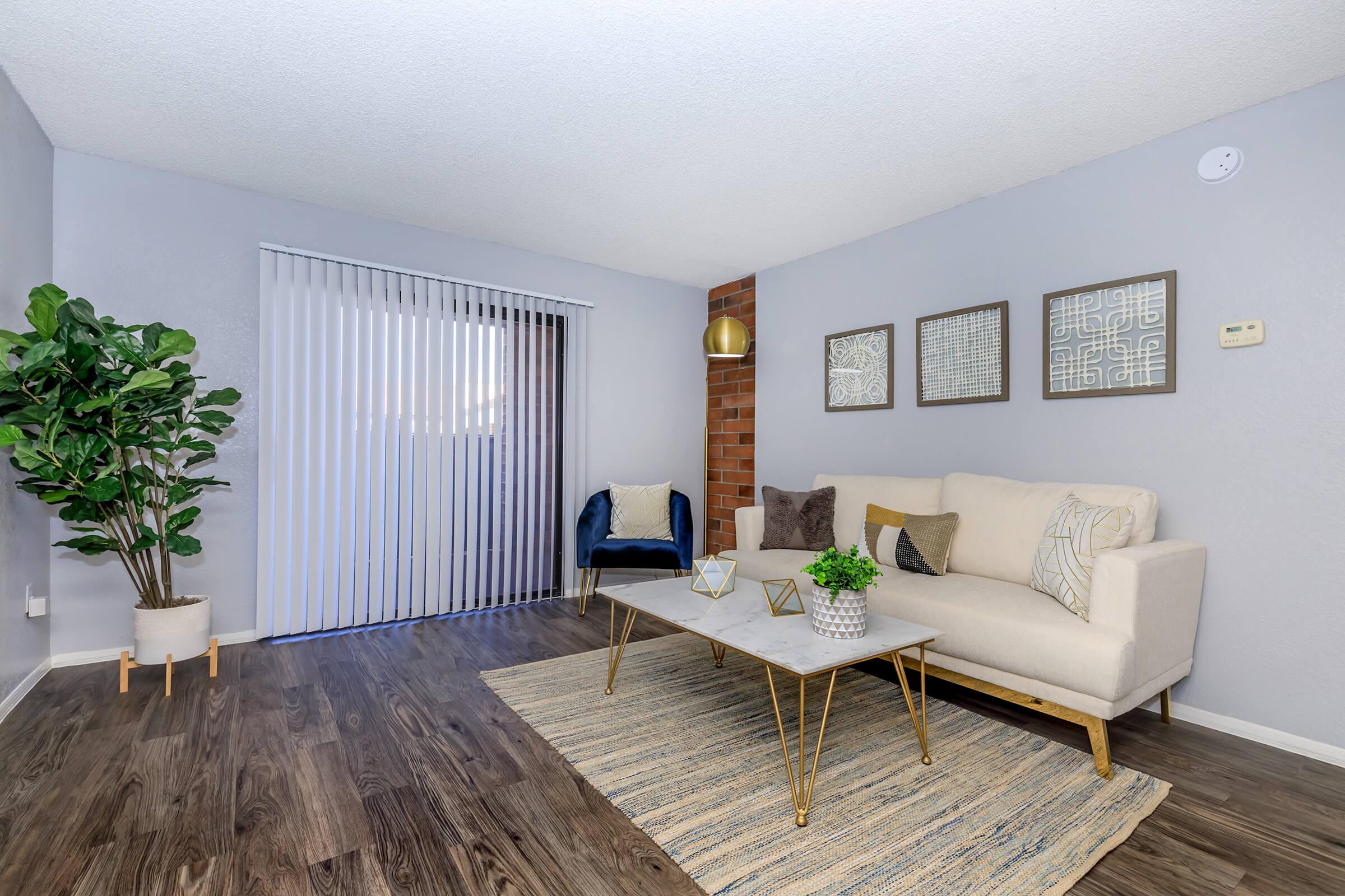 a living room filled with furniture and a flat screen tv