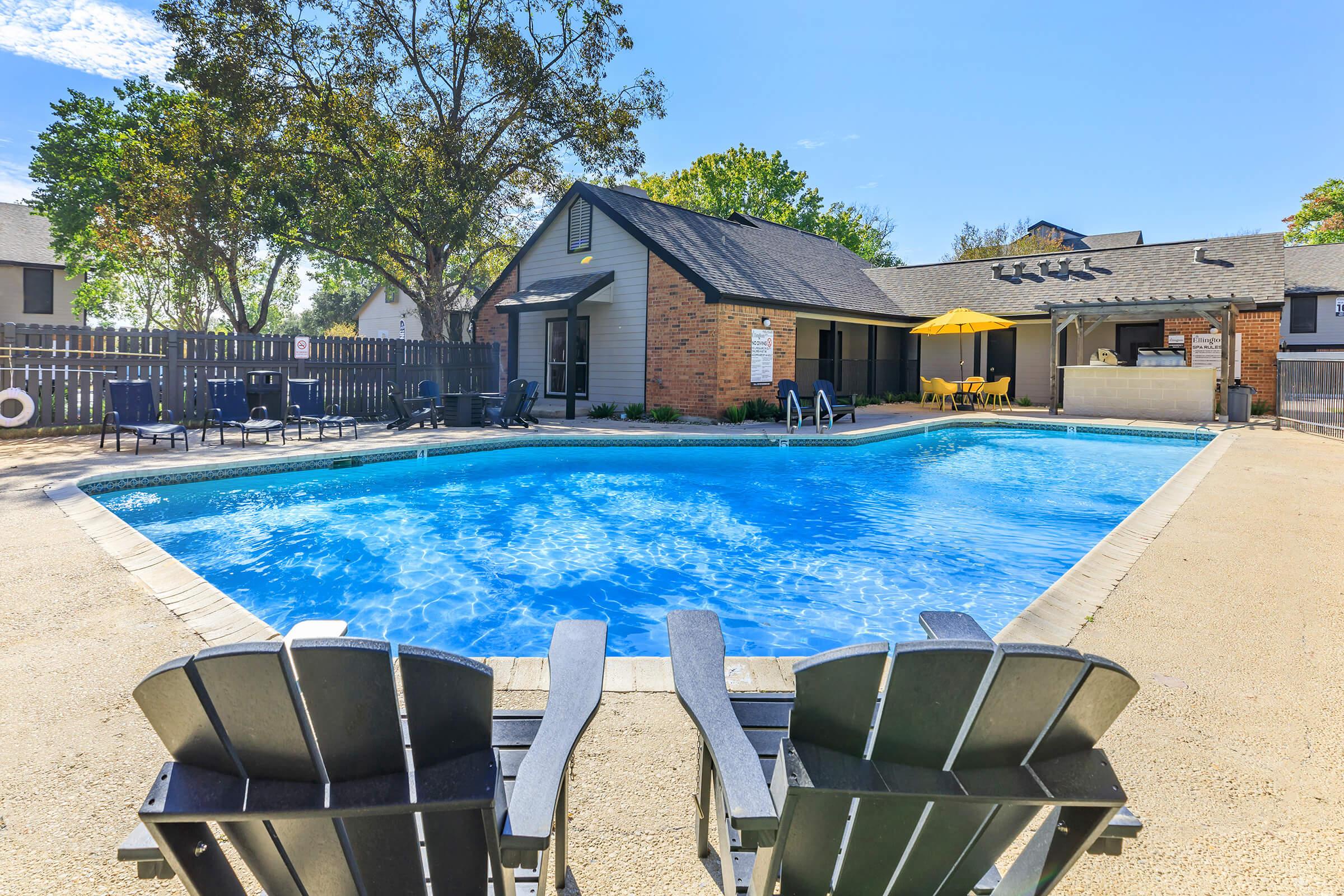 a house with a pool in front of a building