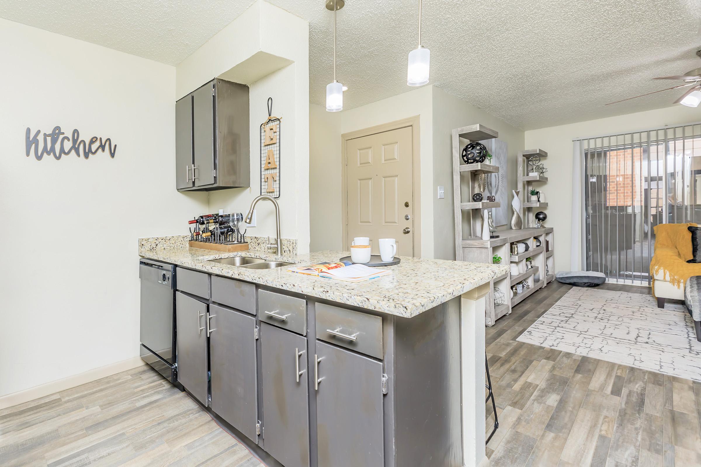 a kitchen with a sink and a mirror