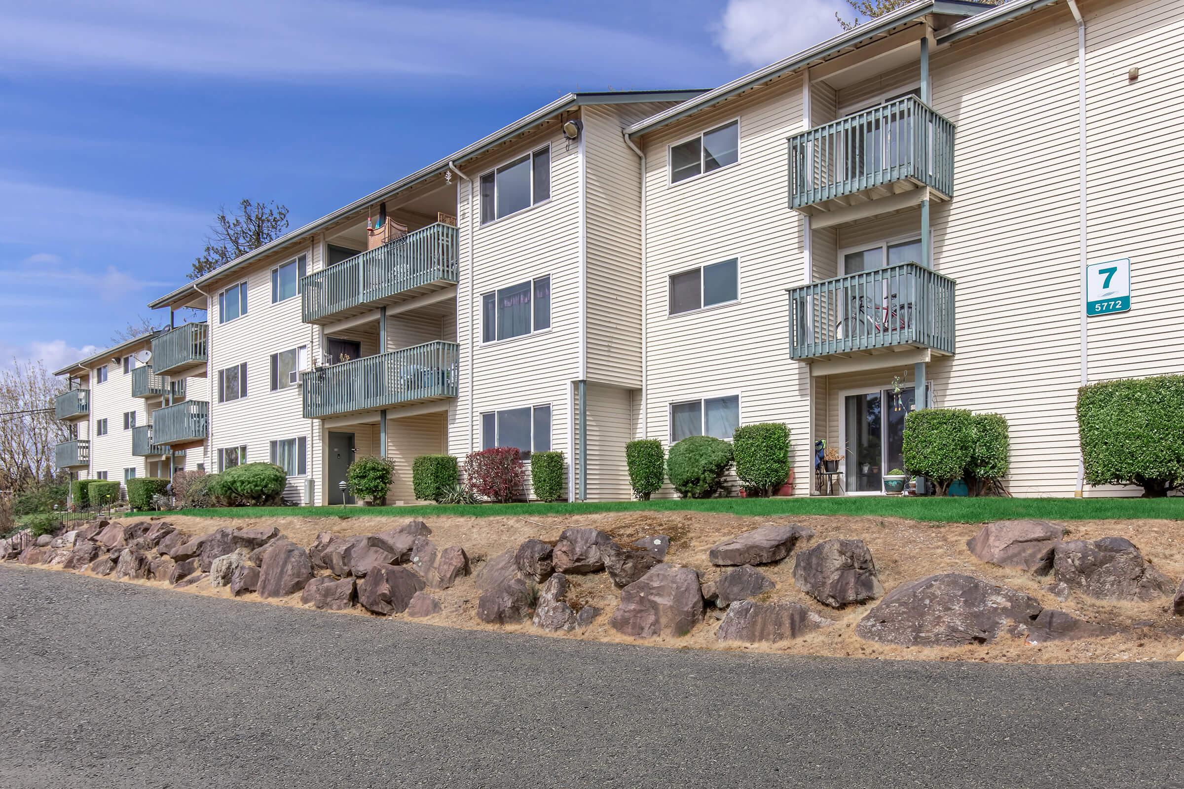 a flock of sheep in front of a building