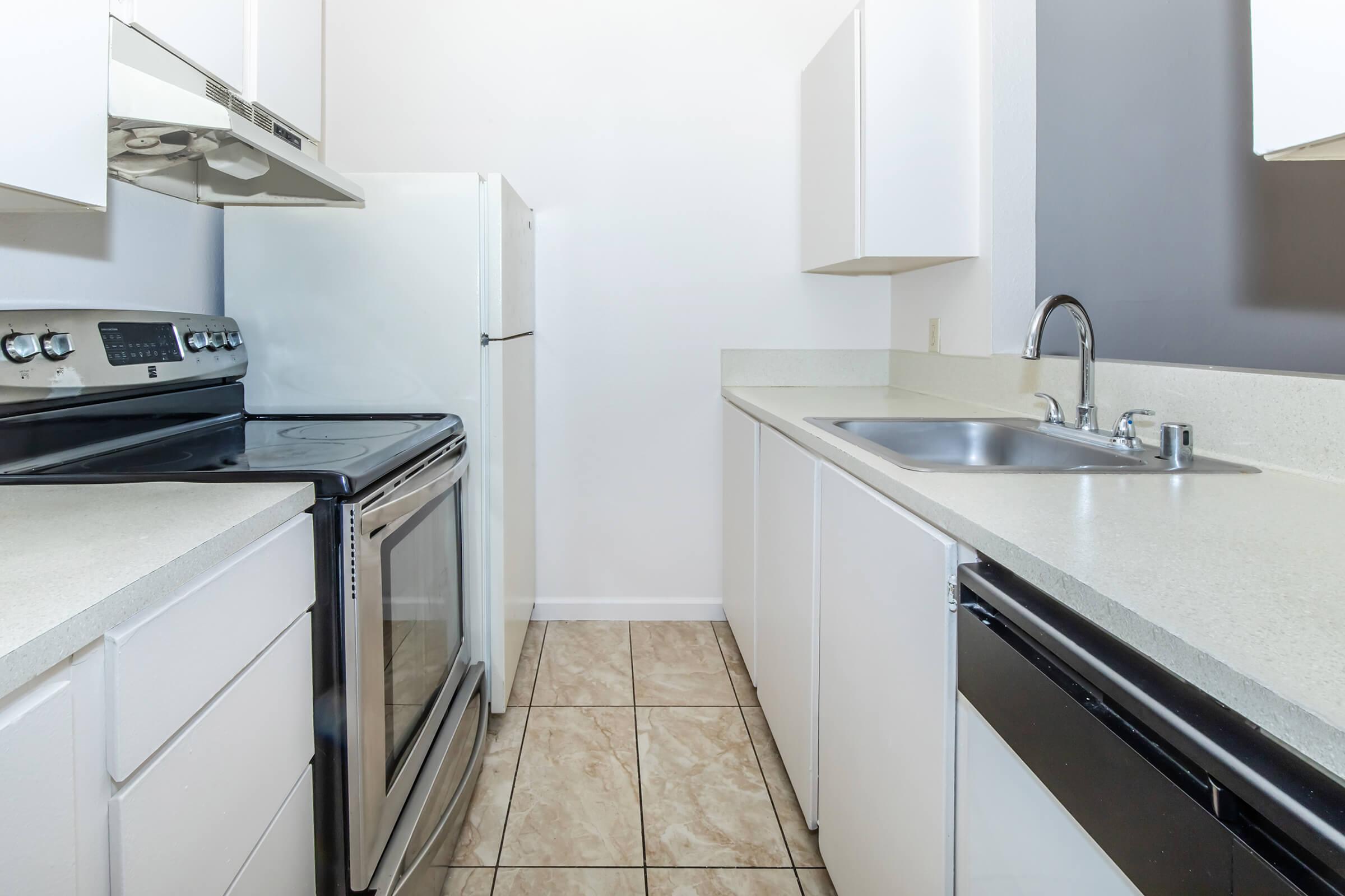 a kitchen with a sink and a mirror