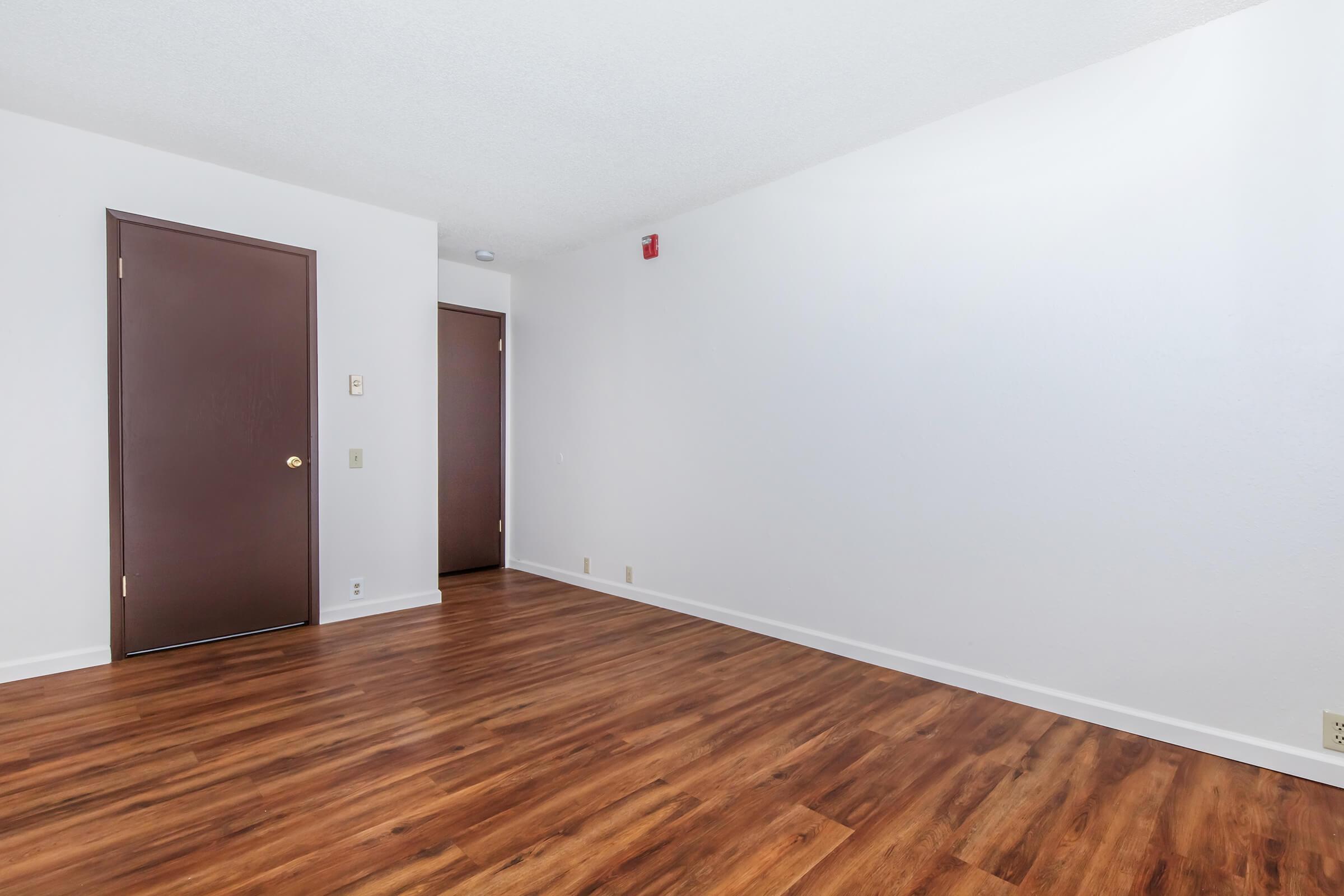 a large empty room with a wood floor