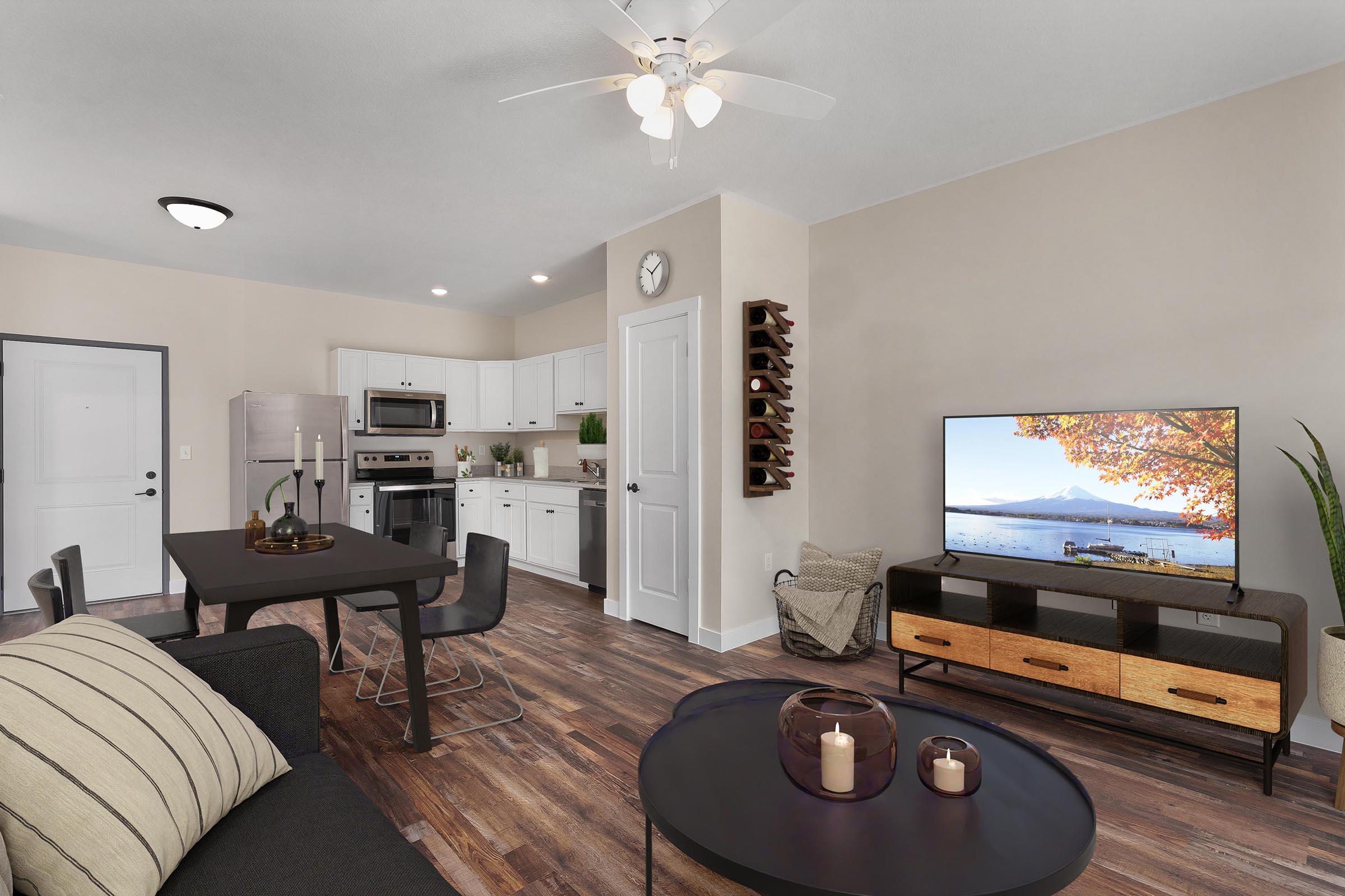 a living room filled with furniture and a flat screen tv