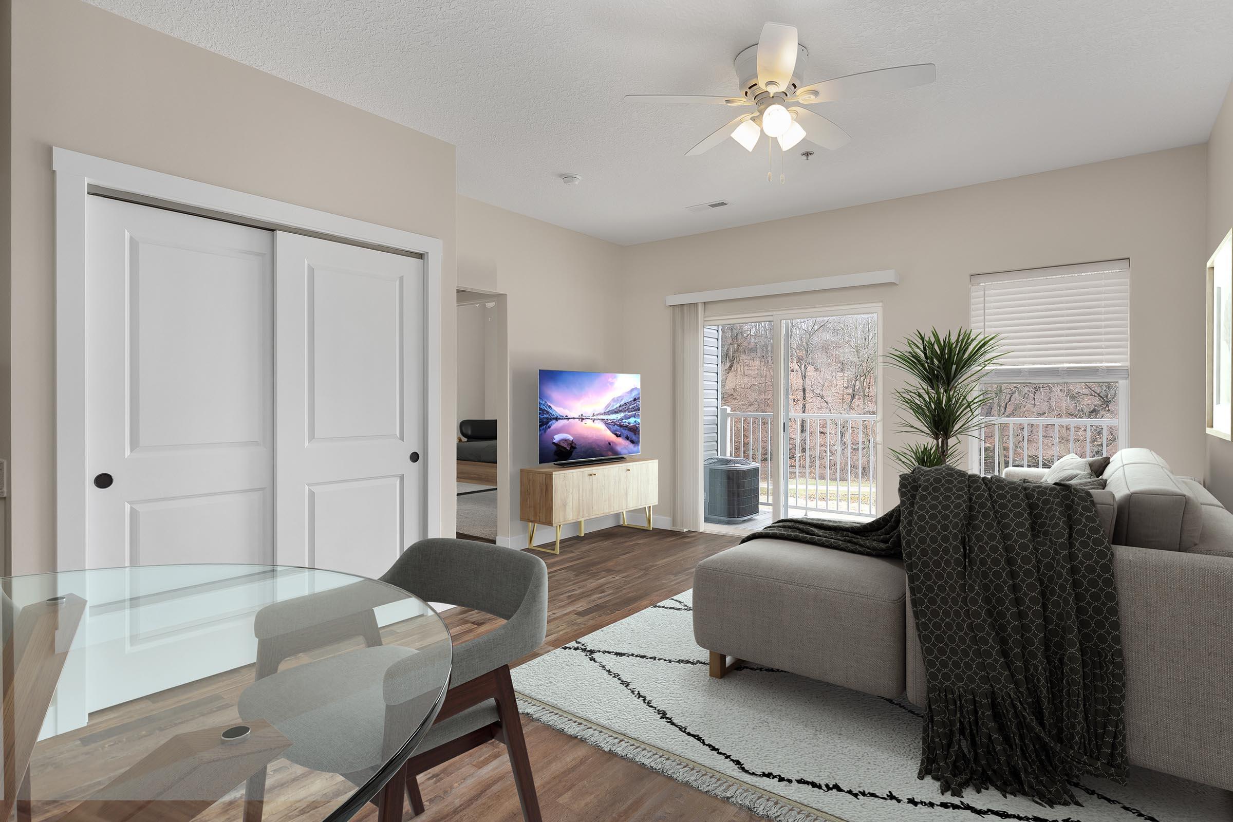 a living room filled with furniture and a large window