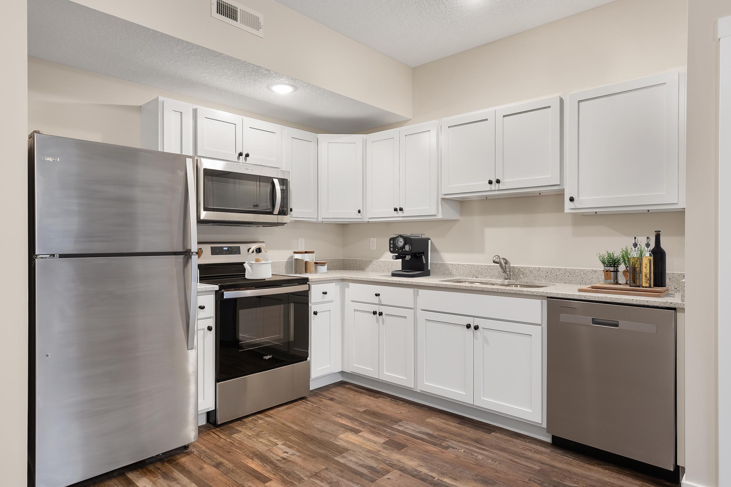 a kitchen with a stove and a refrigerator