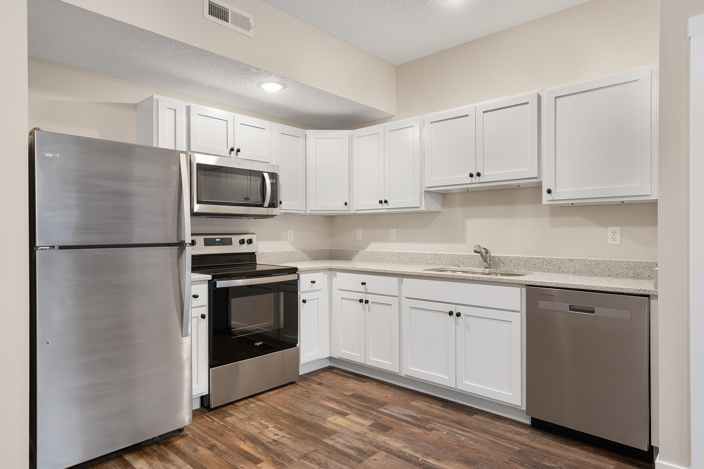 a kitchen with a stove and a refrigerator