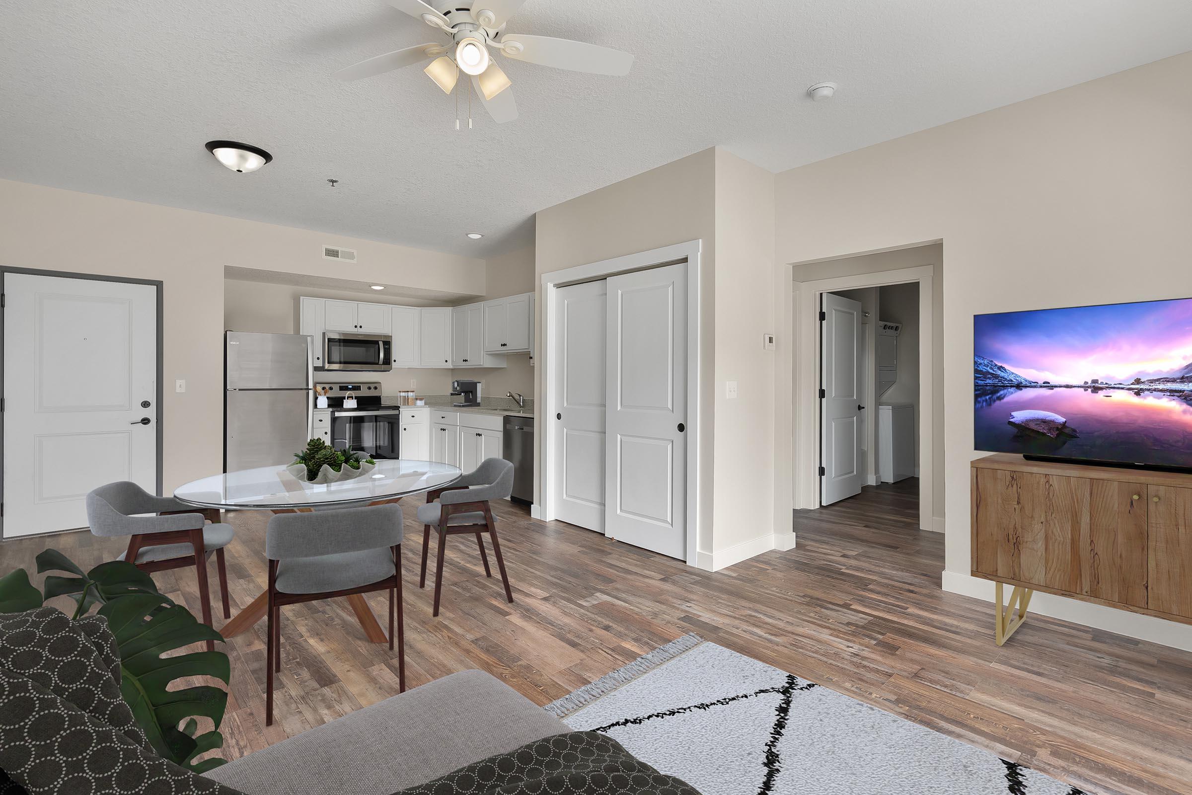 a living room filled with furniture and a flat screen tv