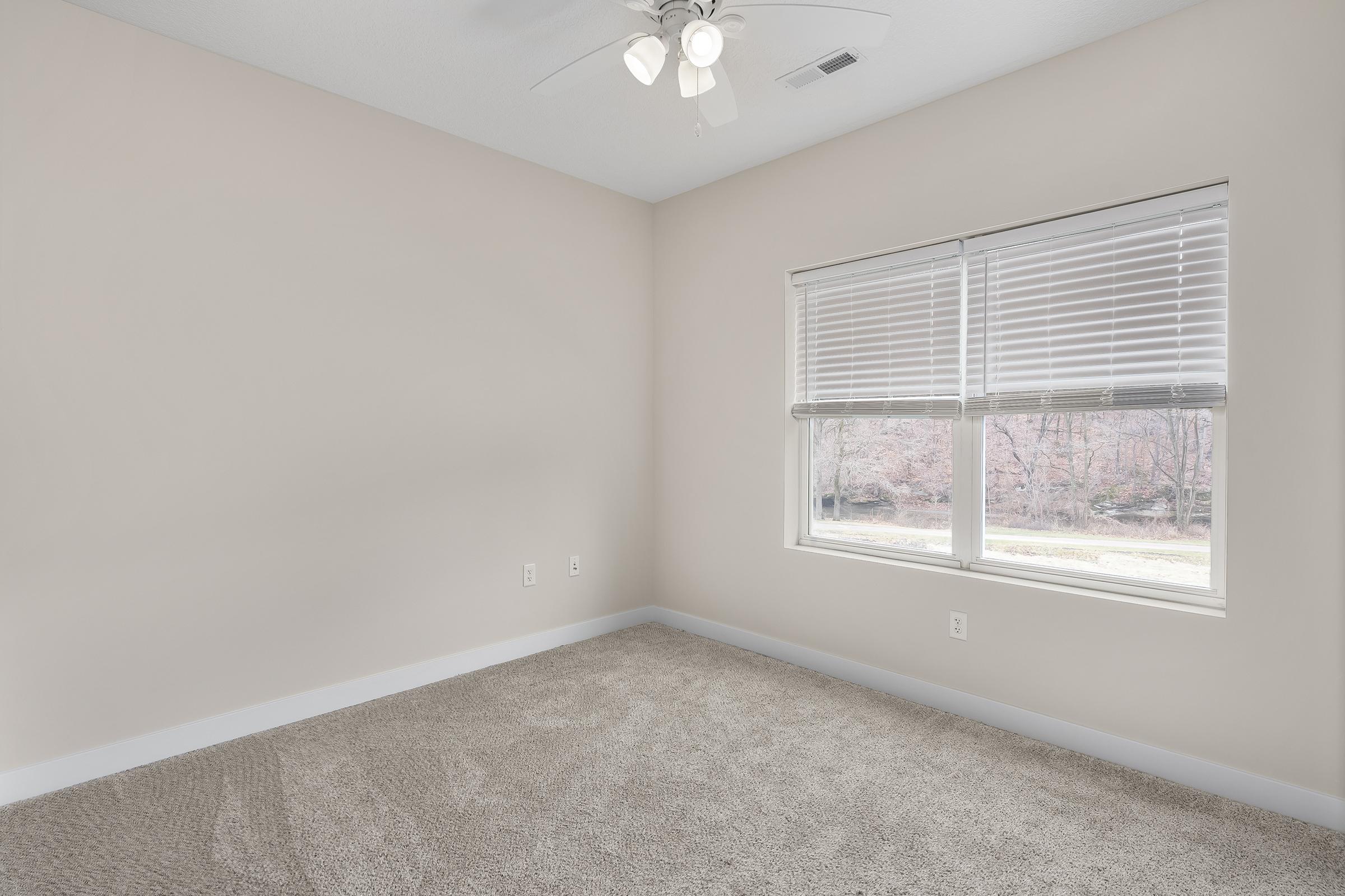 a bedroom with a large window