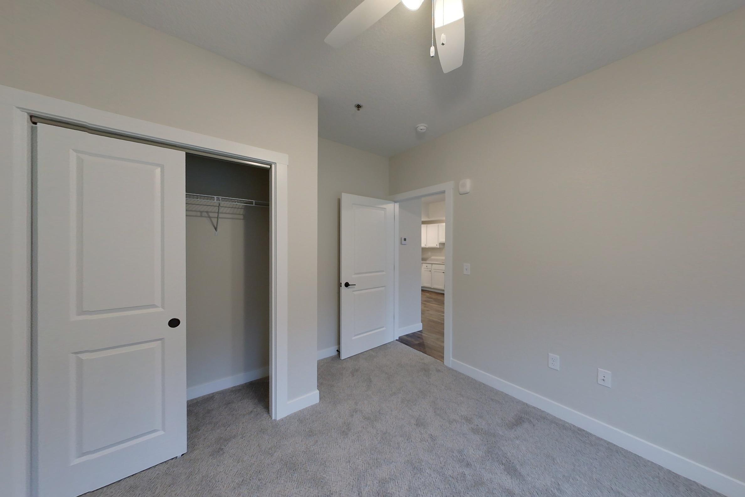 a large empty room with a sink and a mirror