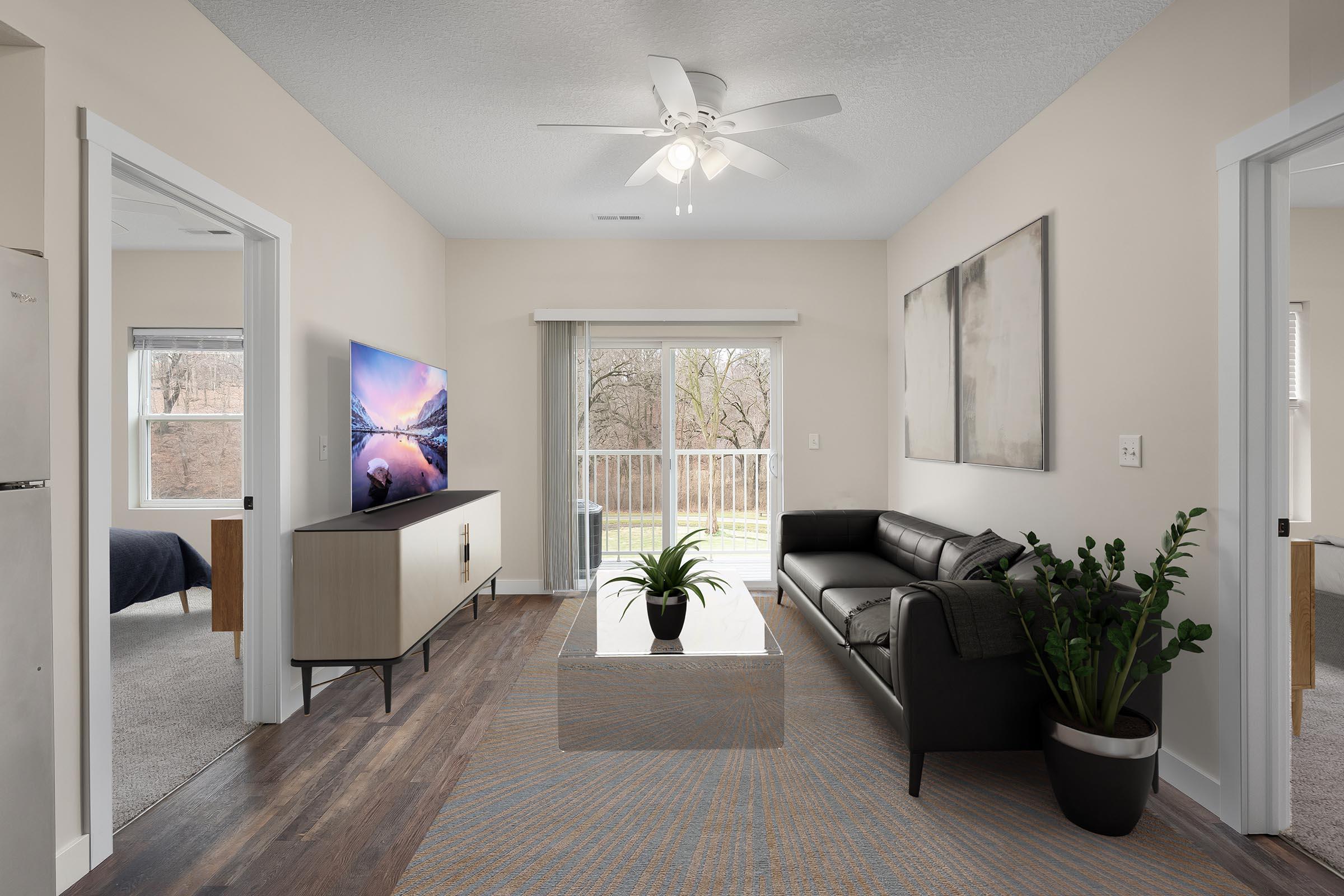 a living room filled with furniture and a large window