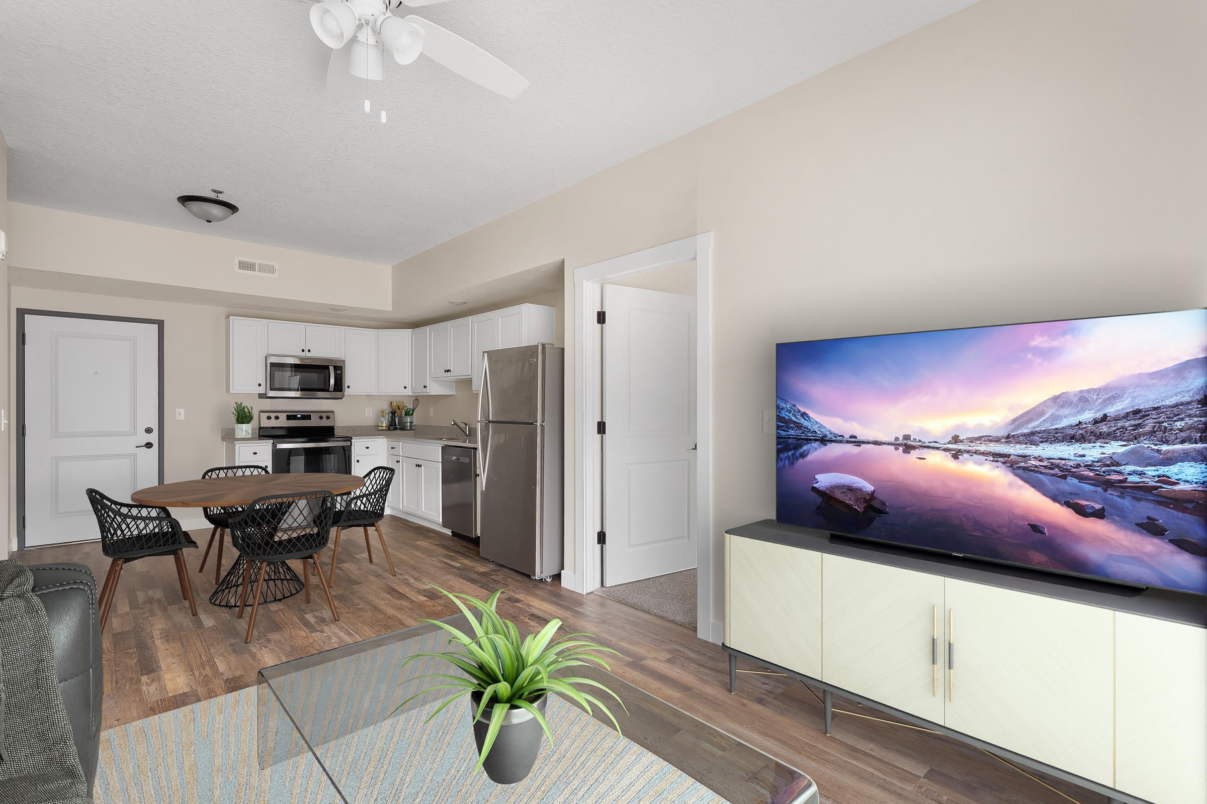 a living room filled with furniture and a flat screen tv