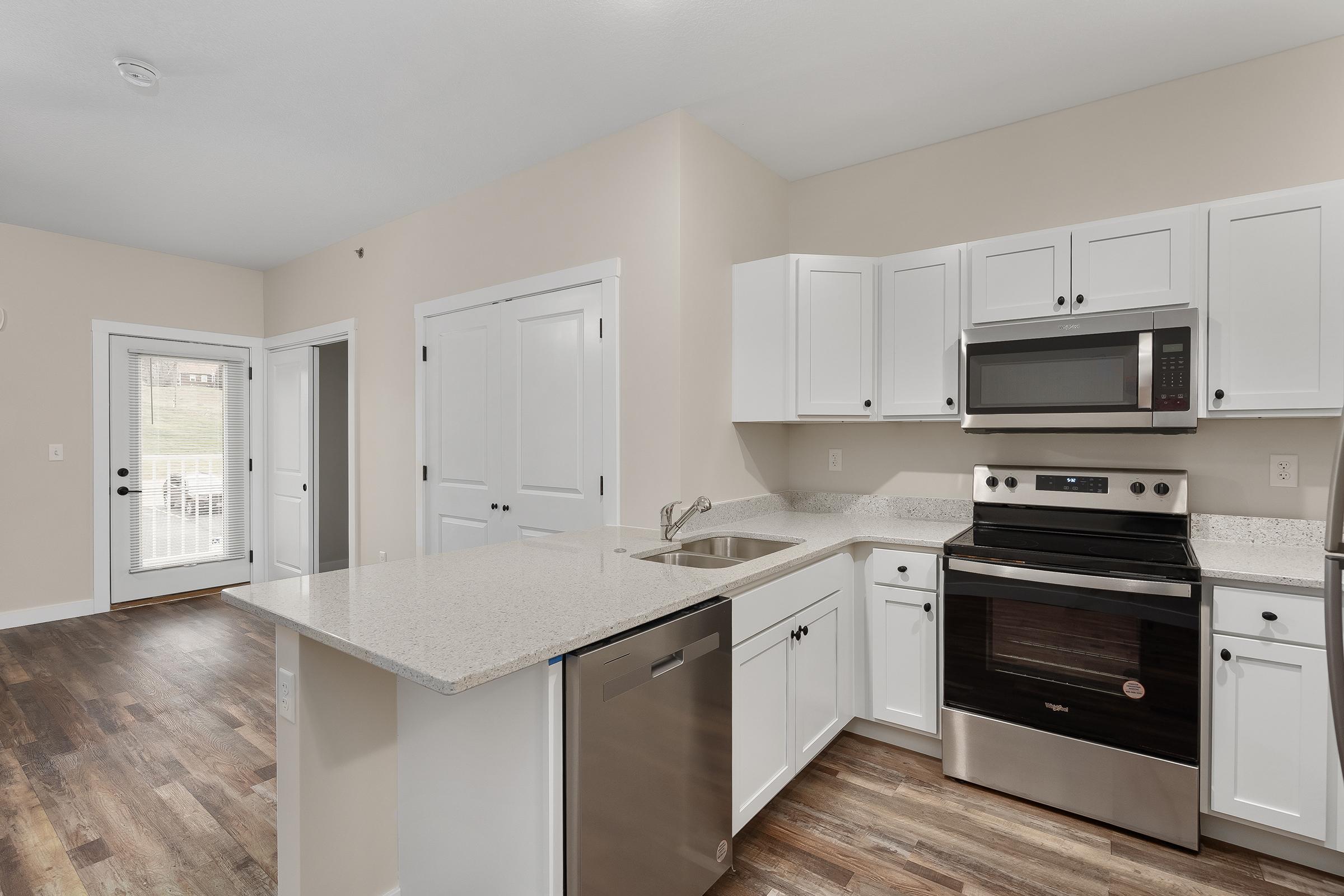 a kitchen with a stove and a refrigerator