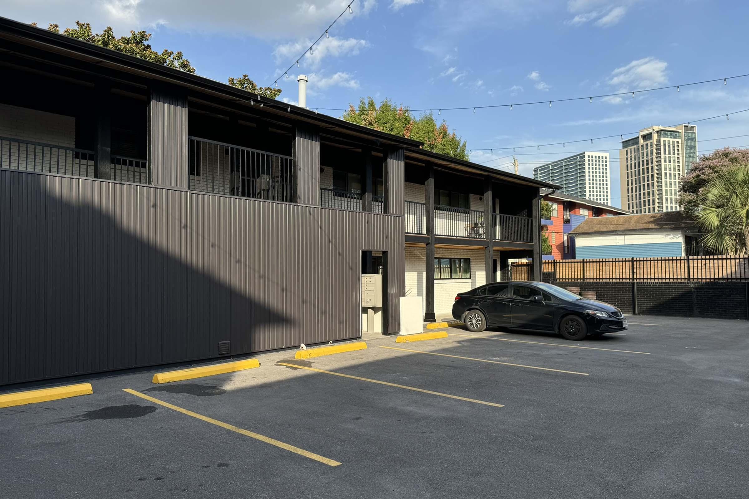 a street with cars parked on the side of a building