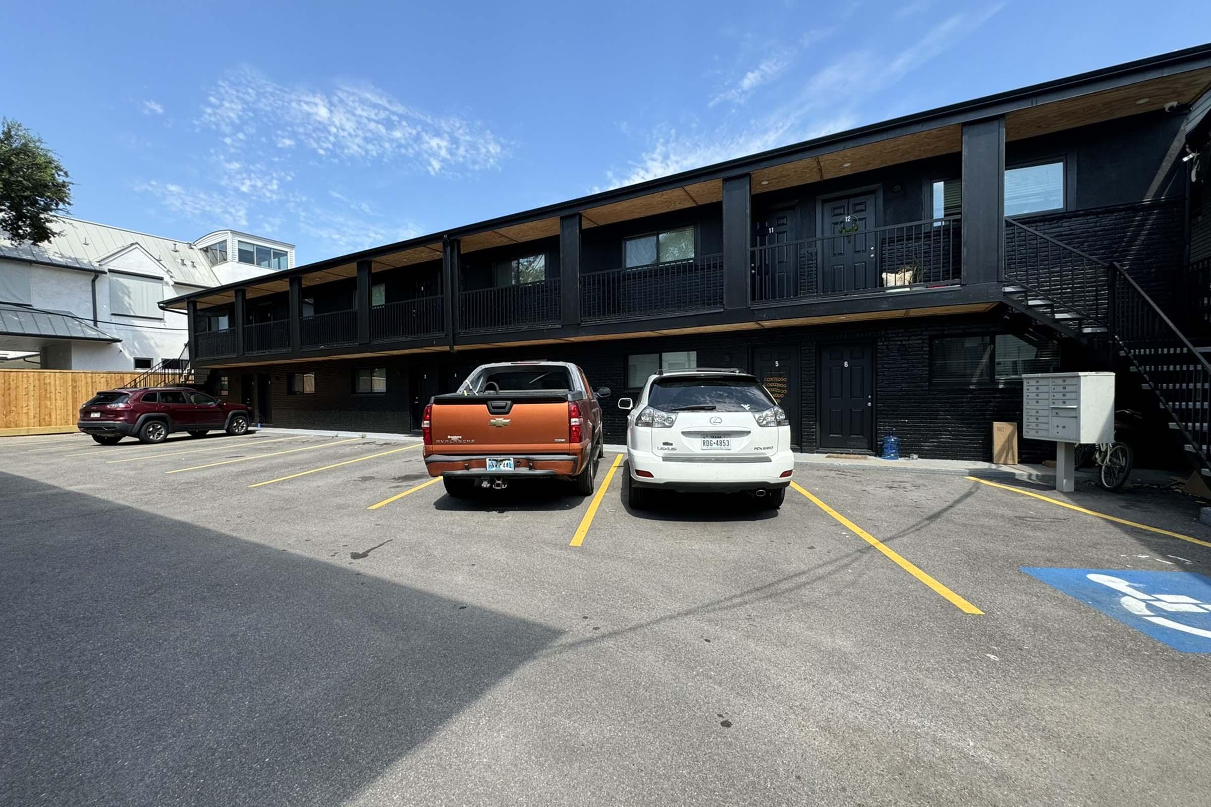 a car parked in a parking lot in front of a building