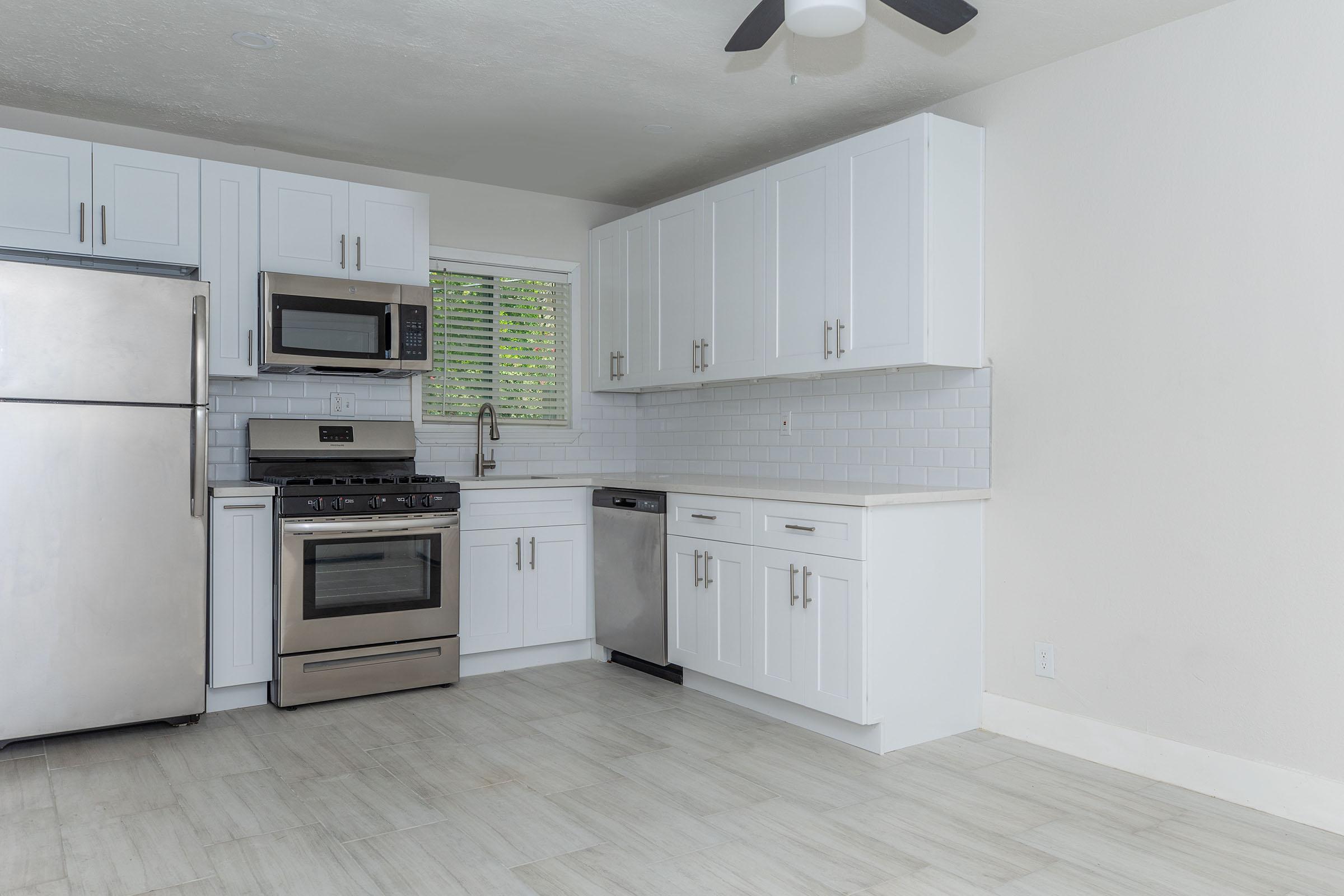 a kitchen with a stove and a refrigerator