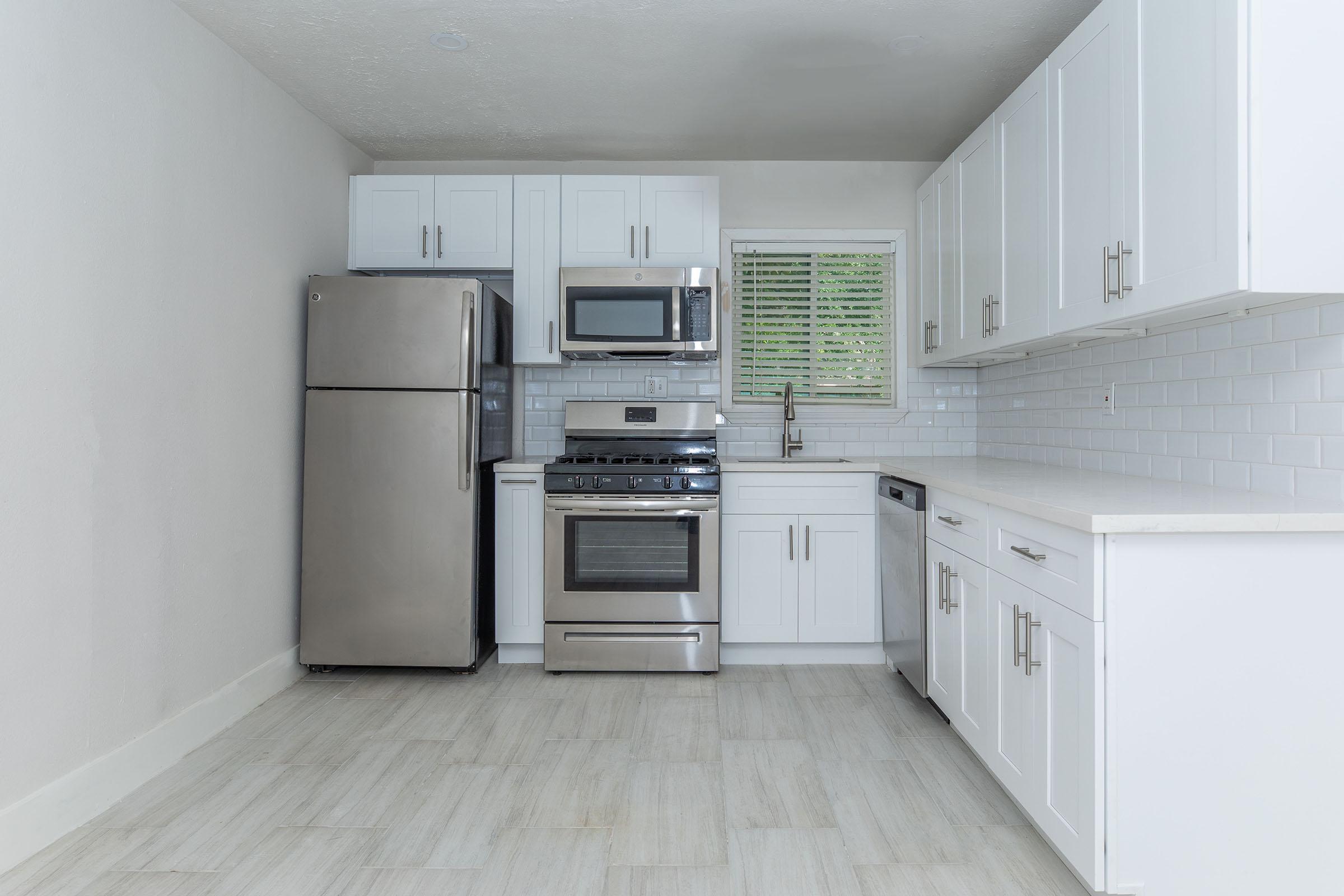 a kitchen with a stove and a refrigerator