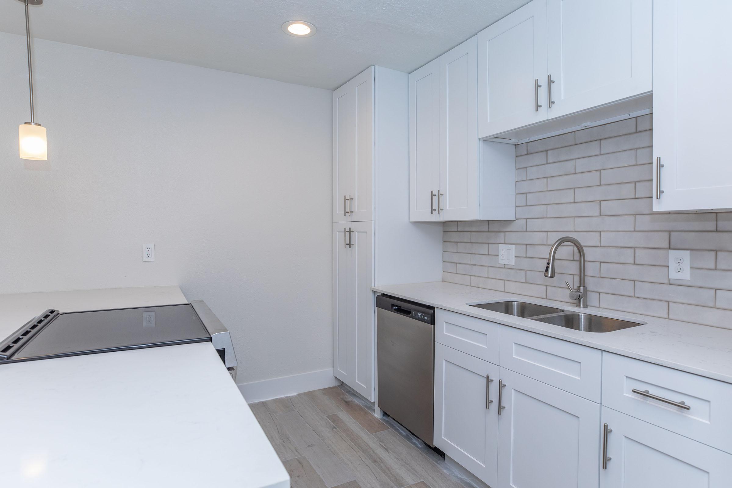 a kitchen with a sink and a mirror