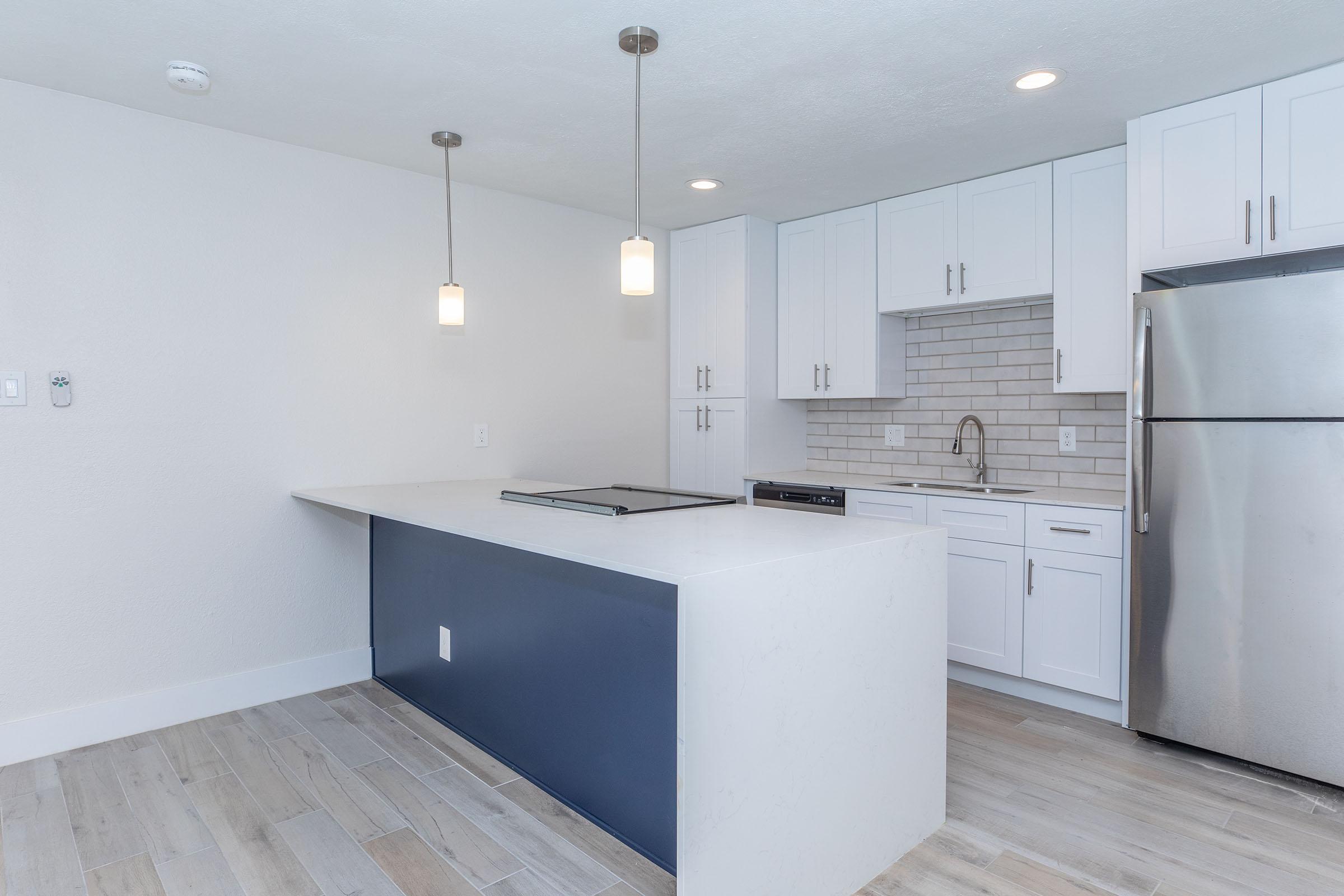 a kitchen with an island in the middle of a room