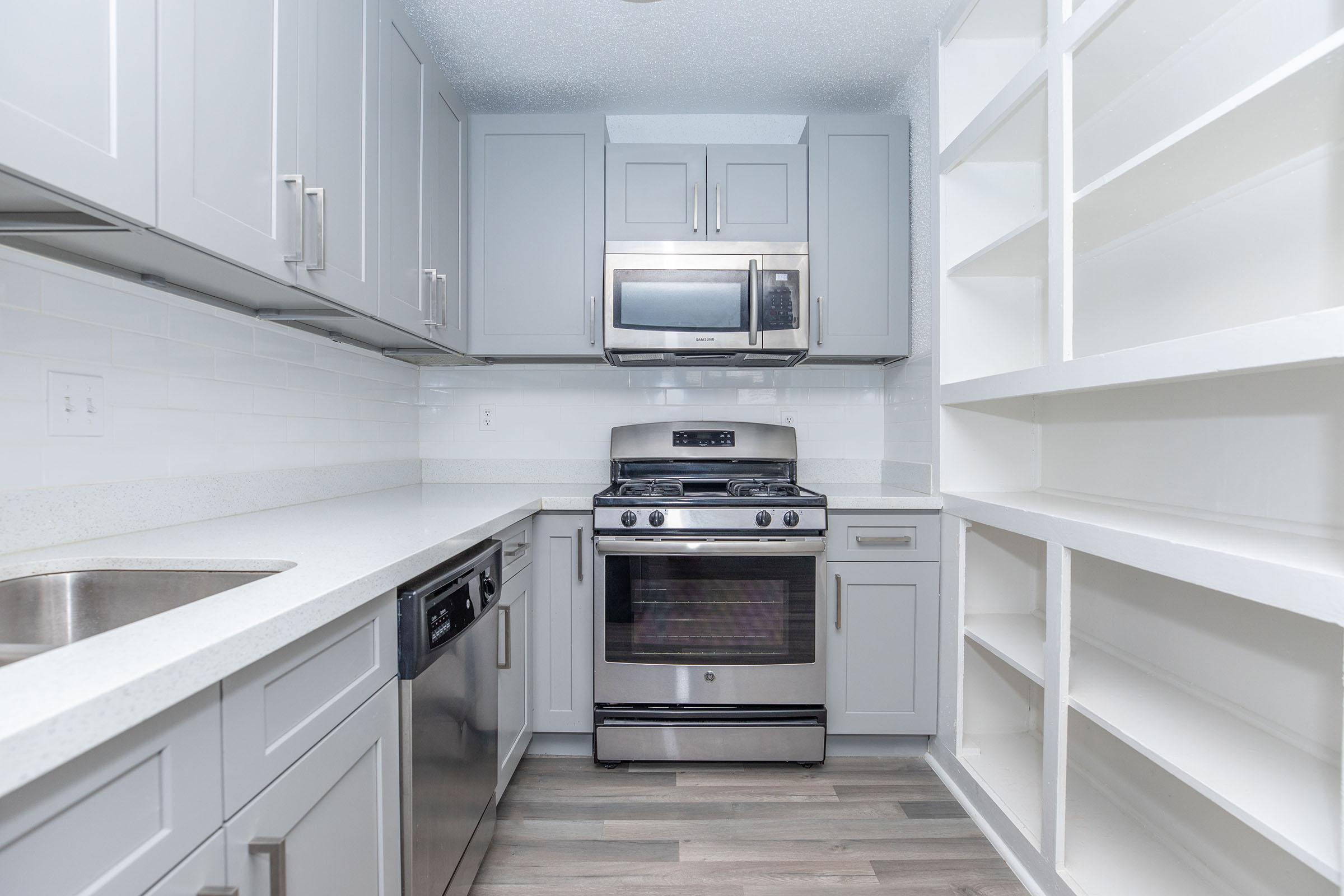 a stove top oven sitting inside of a kitchen