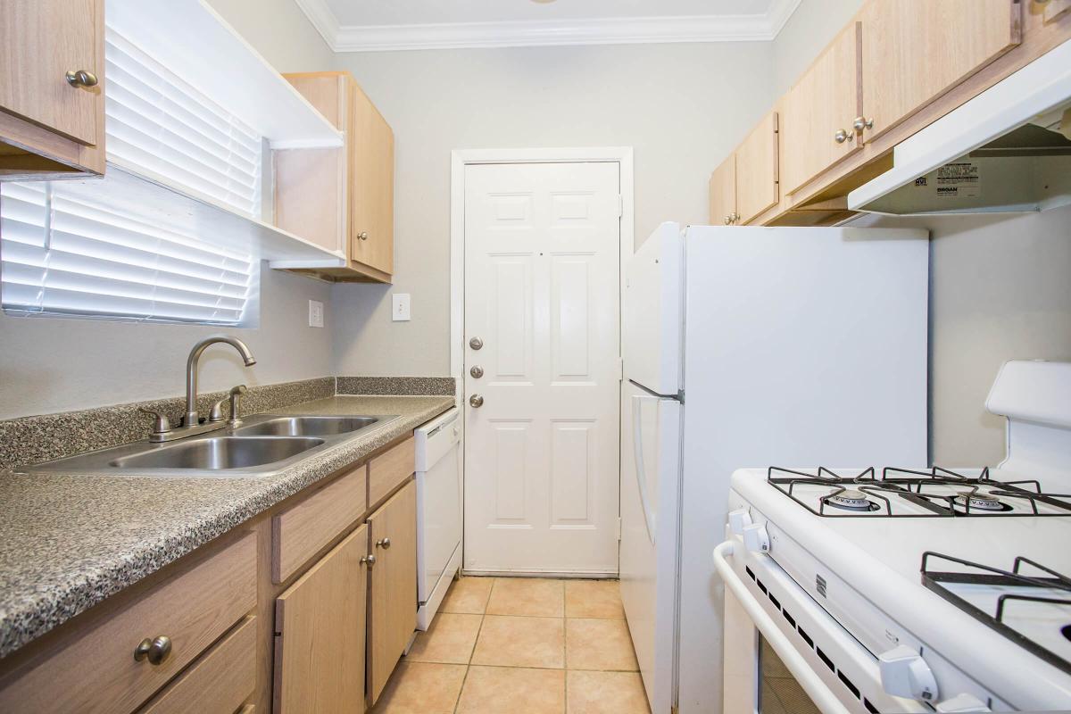 a kitchen with a stove and a sink