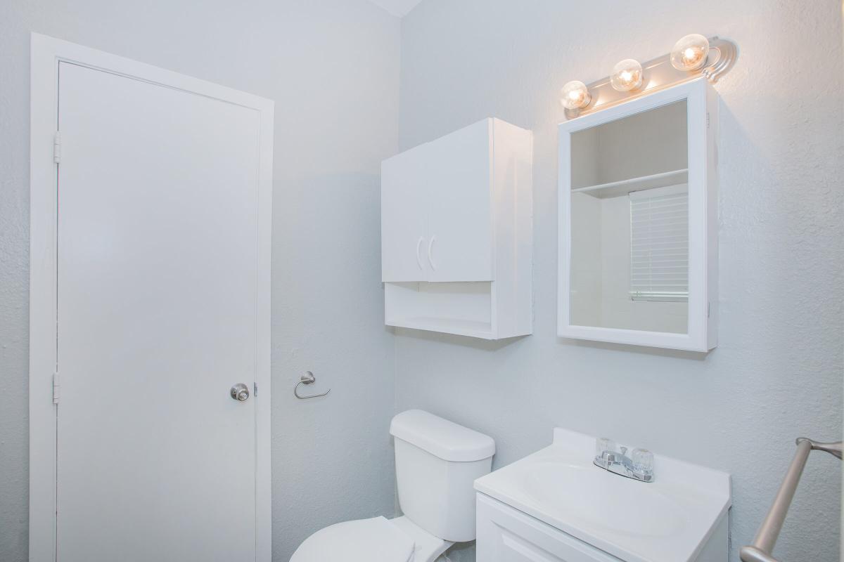 a white sink sitting next to a door