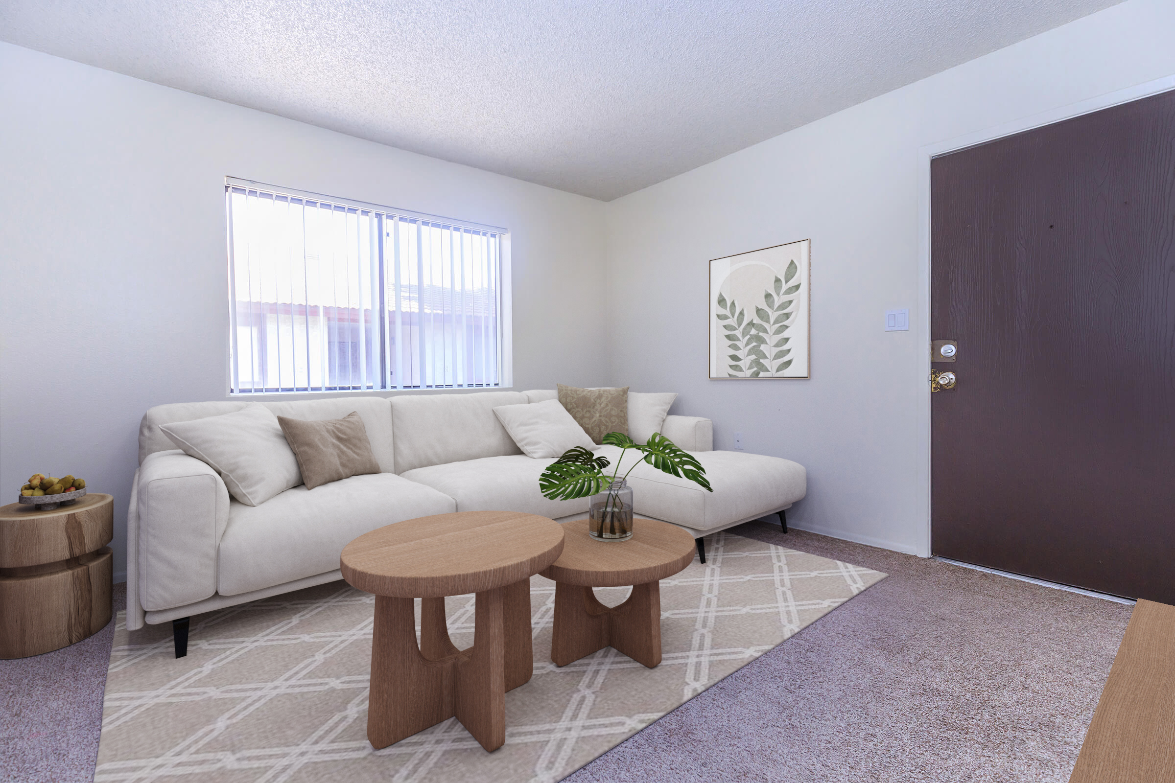 A modern living room featuring a white sectional sofa with beige cushions, two wooden coffee tables, and a decorative plant in a glass vase. A window with sheer curtains lets in natural light, and a framed botanical print adorns the wall beside the door. The plush carpet adds warmth to the space.