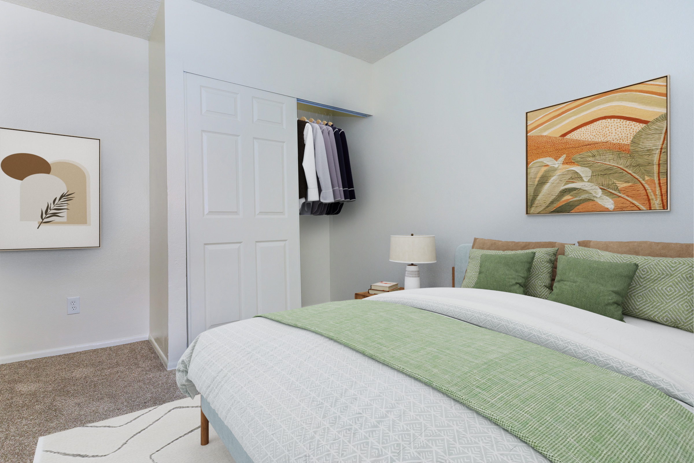 A cozy bedroom featuring a neatly made bed with green and white bedding, a bedside lamp, and a piece of abstract artwork on the wall. A closet with hanging clothes is visible, alongside a light-colored rug on the carpeted floor. The overall aesthetic is calm and inviting with neutral tones.