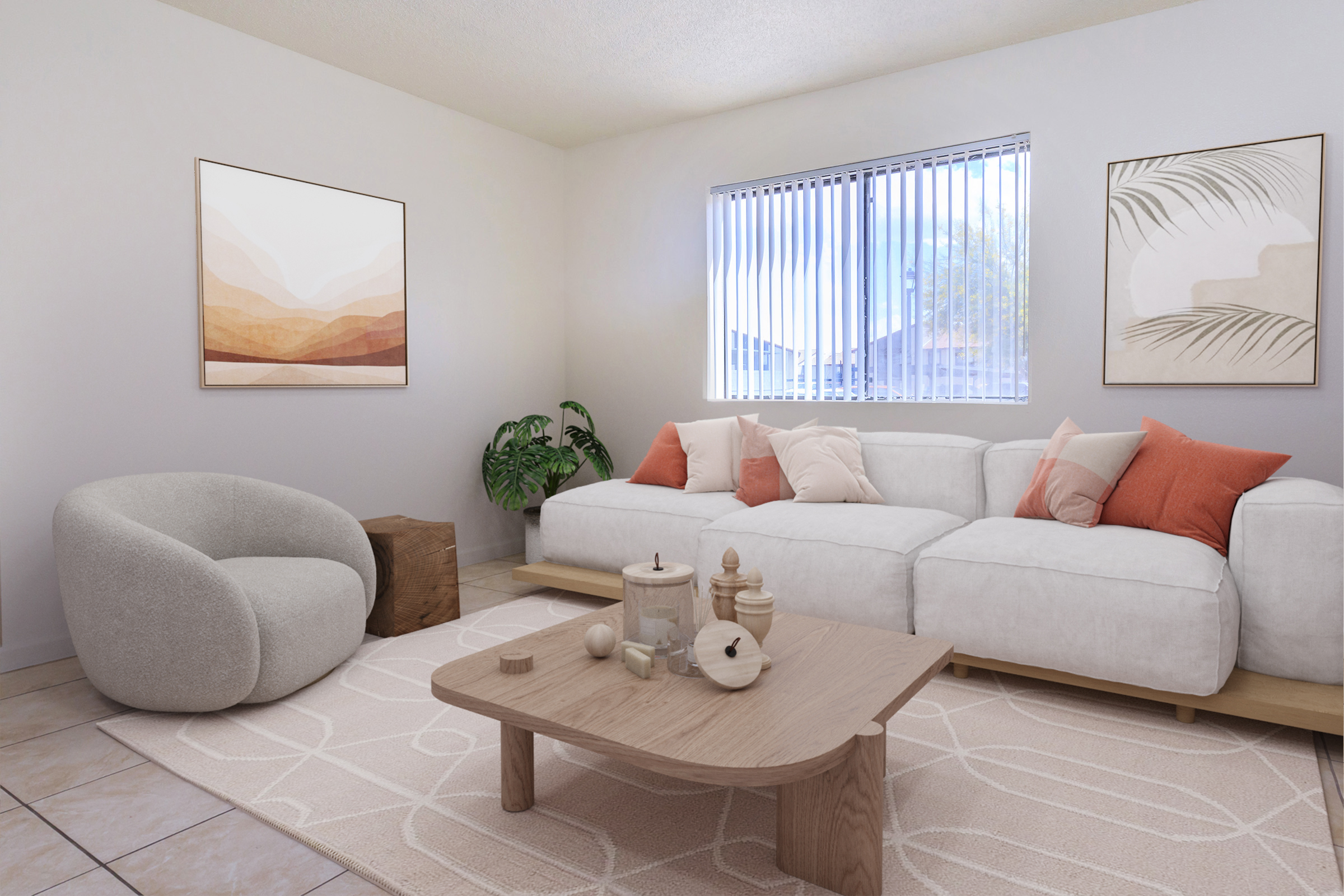 A modern living room featuring a light-colored, L-shaped sofa adorned with orange and beige pillows. A round, soft chair sits nearby, alongside a wooden coffee table with decorative items. The room has neutral walls, large windows with blinds, and artwork depicting abstract landscapes. A potted plant adds a touch of greenery.