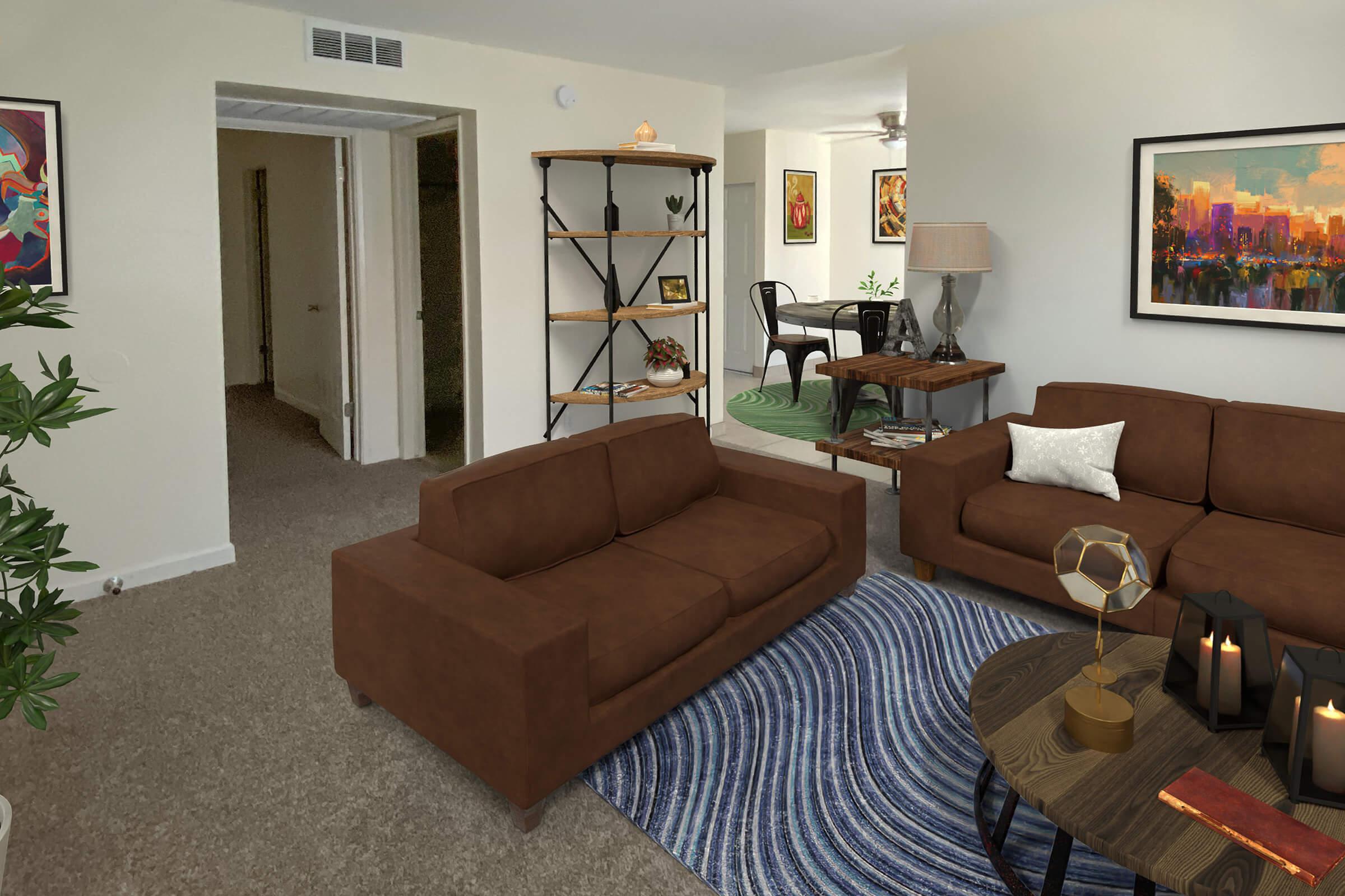 A cozy living room featuring two brown sofas facing a round coffee table with decorative items. In the background, there’s a bookshelf, a lamp, and artwork on the walls. A green area rug adds color, while an open doorway leads to another room. Natural light filters through the space, creating a warm atmosphere.