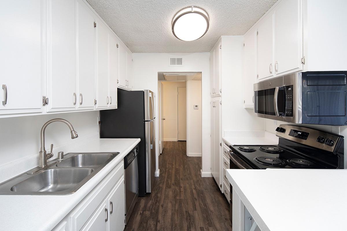 a kitchen with a stove sink and refrigerator