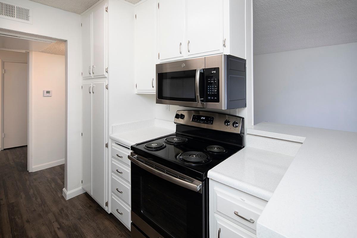 a stove top oven sitting inside of a kitchen