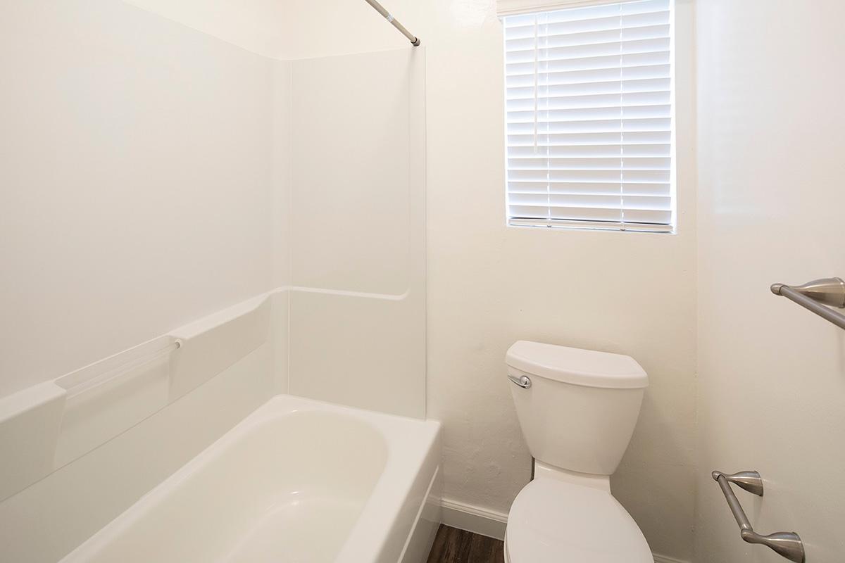 a white tub sitting next to a window