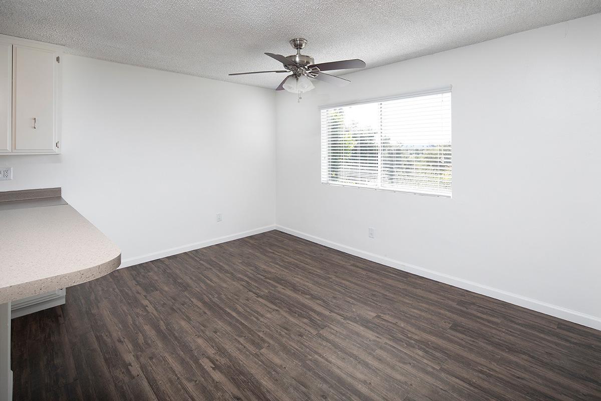 a bedroom with a wooden floor