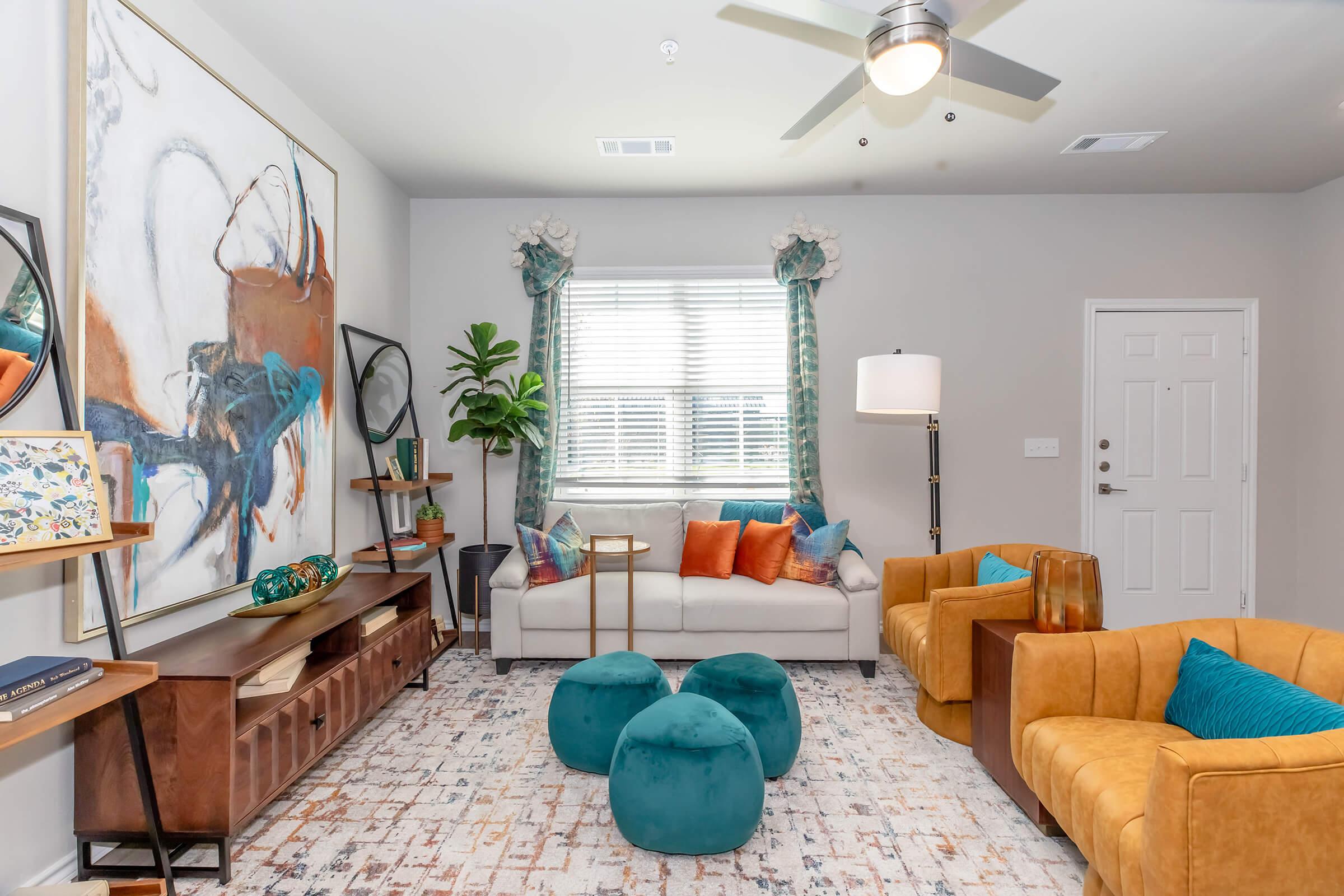 a living room filled with furniture and a window