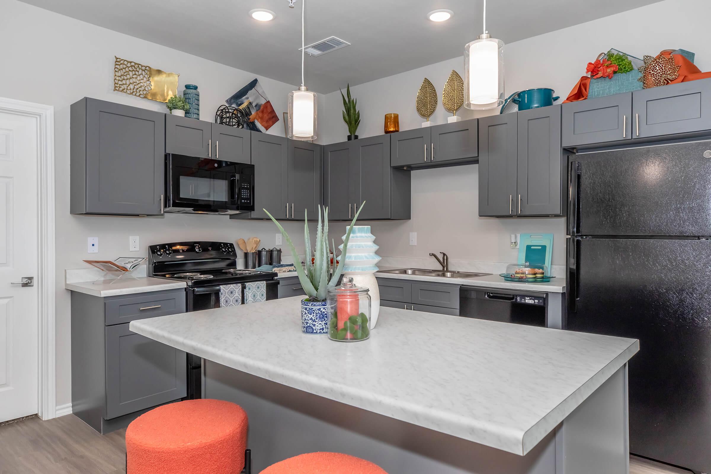 a modern kitchen with an island in the middle of a room