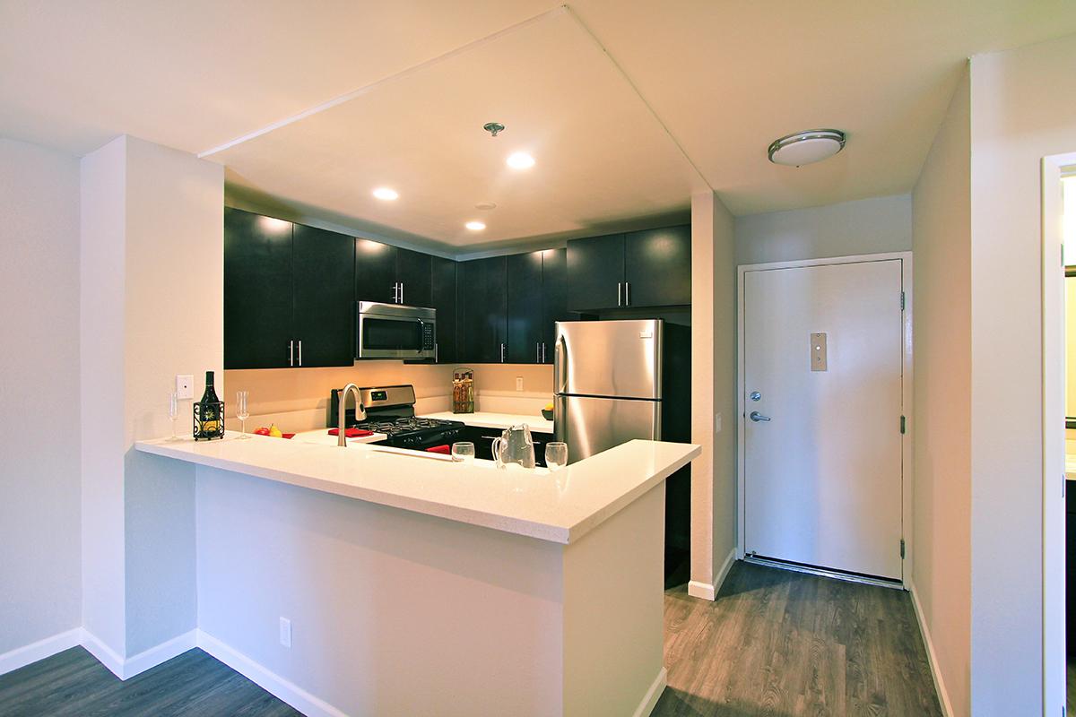 a kitchen with a sink and a mirror