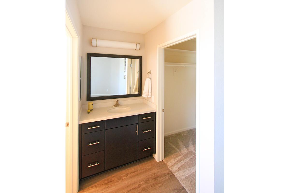 a kitchen with a sink and a mirror