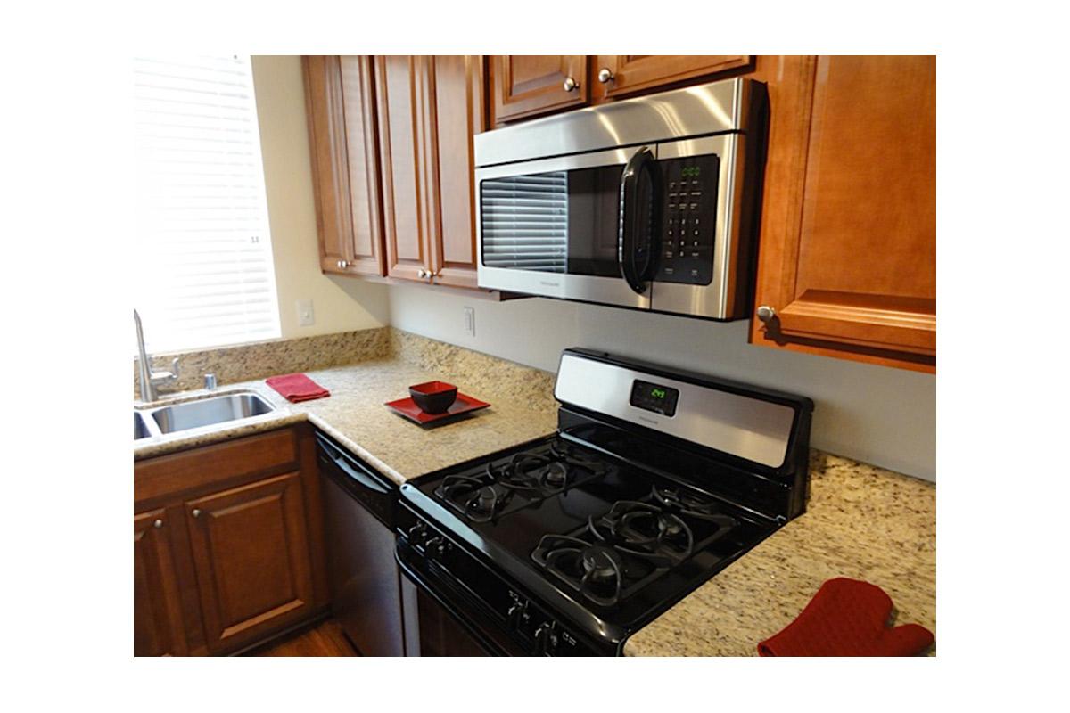 a stove top oven sitting inside of a kitchen